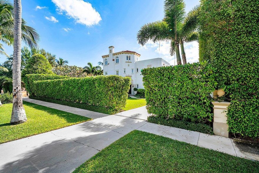 Stunning ocean block estate blending timeless architecture with modern luxury on pristine Brazilian Avenue in the heart of town. Sited on a 12,825 sq ft lot, this renovated Mediterranean Revival estate rises 3 stories and includes a 4-bedroom, 4.5-bath main residence and a beautifully appointed 2-bedroom/2 bath guest house. Filled with natural light and exquisite details, the home features a double living room with fireplace, 10' ceilings, formal dining room, library, and inviting family room. Chef's kitchen with Lacanche range, marble counters, custom island and built ins. French doors throughout lead to a covered coquina stone patio and heated salt water pool. Primary suite with marble fireplace, walk-in closet and elegant bath. 3 additional en-suite bedrooms, light oak wood floors