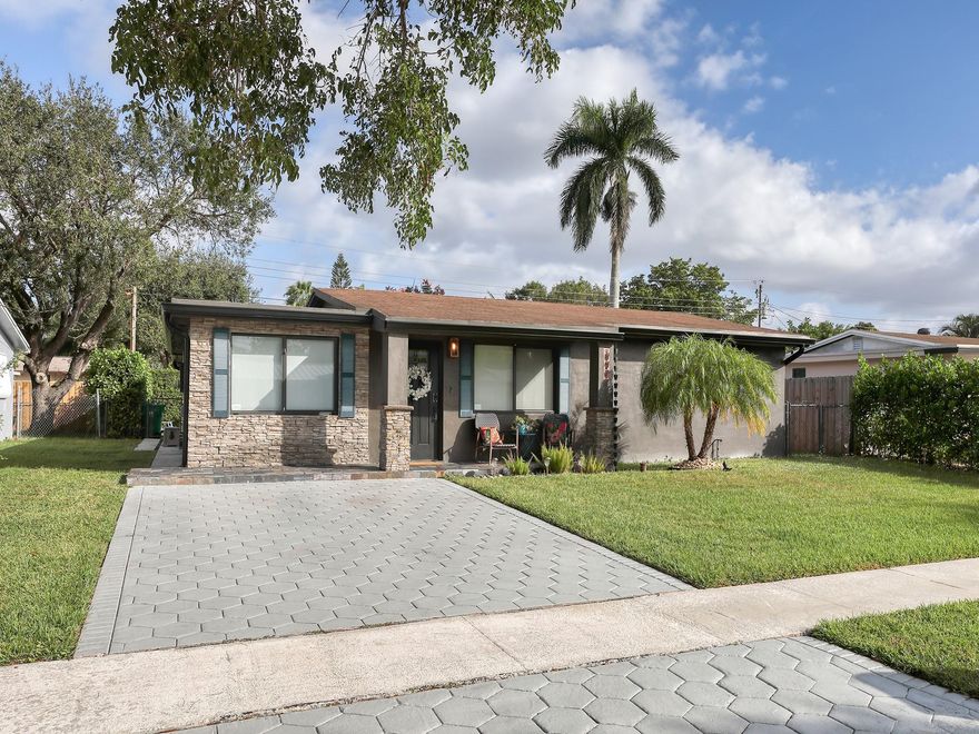 Discover the essence of charming in this Cooper City Gem!  This 1,300+ sq. ft. home with great curb appeal, a fresh manicured lawn welcomes you home. Step inside to find a living room with custom wallpaper, setting the tone for a stylish comfort.  Tiled thought-out the house provides durability and easy maintenance, the laminate flooring in the bedrooms is a rich wood color making it very relaxing.  Custom window treatments adds a touch of elegance, while the stainless steel appliances and recess lighting makes this kitchen a joy for any chef. The dining room area is bathed in beautiful natural light, creating a warm and inviting atmosphere.  The large backyard is adorned with pavers and artificial grass, perfect for outdoor enjoyment and minimal maintenance. Hedges provide ample privacy.