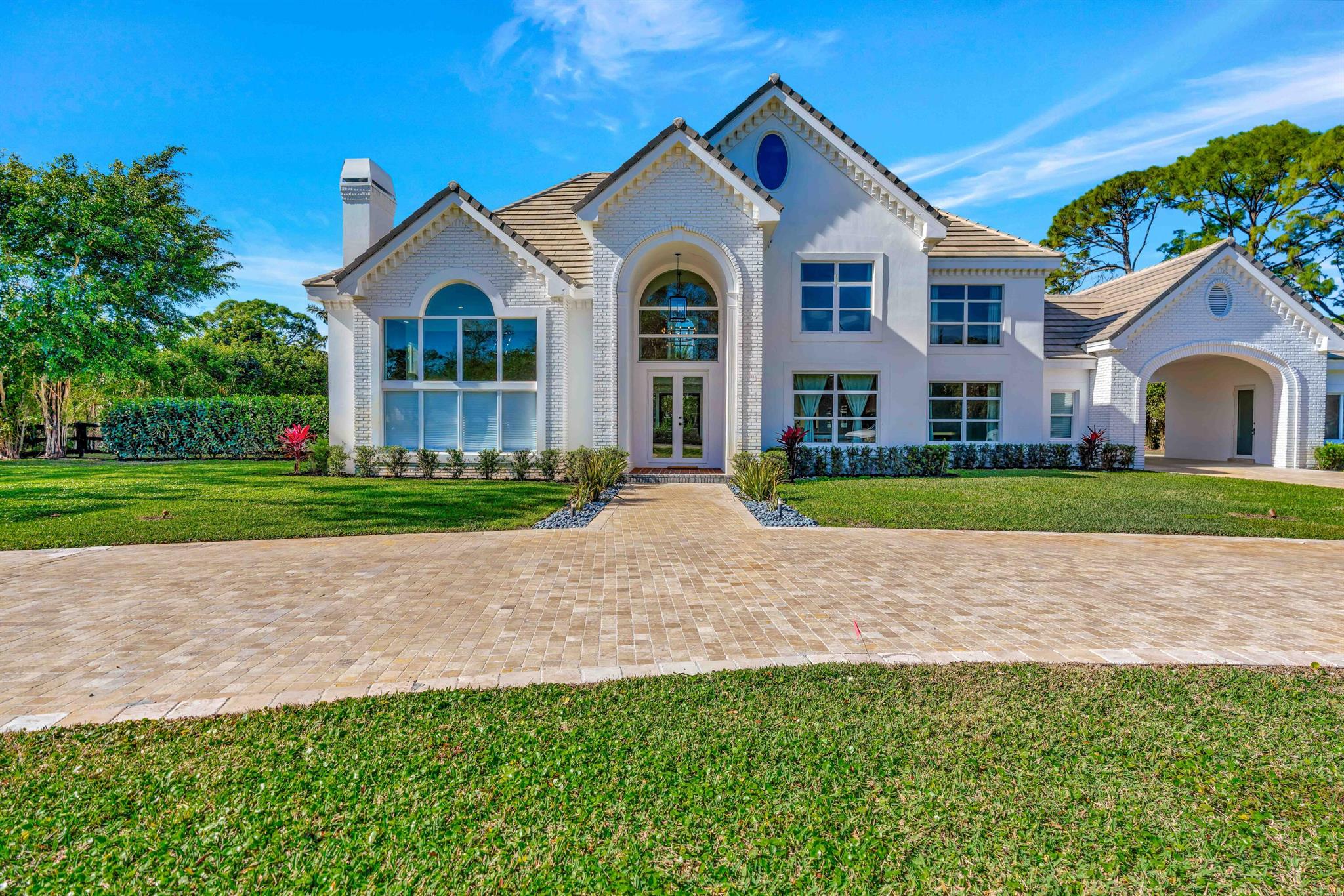 Exceptional Custom-Built Home with Recent Renovations - Experience the perfect blend of luxury and comfort in this newly renovated custom home, thoughtfully designed to cater to every need. Situated on a sprawling 1-acre lot - Spacious and private, offering endless possibilities.- New Hurricane Impact Windows/Doors Ensuring your peace of mind during storm season.Spacious and private, offering endless possibilities. Floating Staircase: A striking architectural feature that adds modern elegance. - Detached Multi-Purpose Space: Perfect for a man cave, she shed, gym, or office. 3 Car Garage with Glass Wall: A showcase for car enthusiasts. - 24/7 Armed Security: Ensuring your safety and peace of mind.