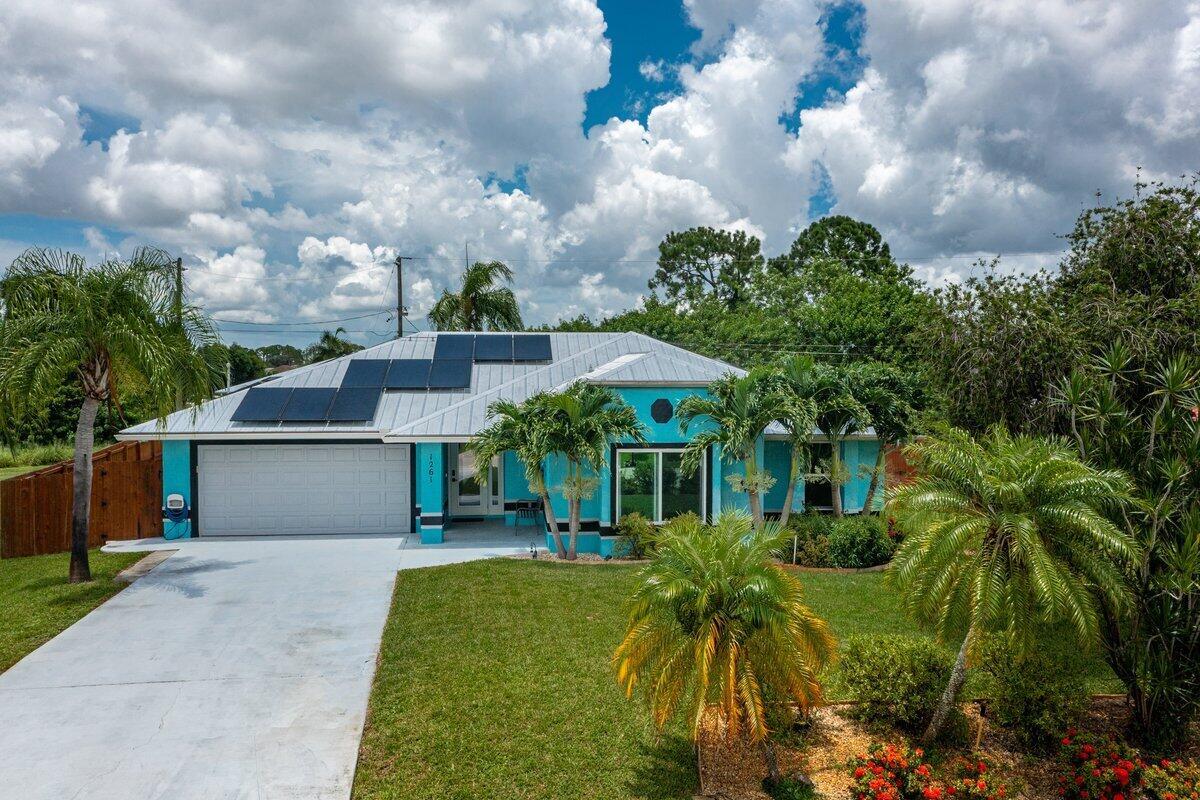 This 3/2.5/2 POOL home is a commuters dream just 1 mile from I-95's Becker Road exit and features a newer metal roof (2016), new A/C (2018),wood-look tile throughout, fresh interior paint . Situated on a cul-de-sac street surrounded by many newly construction homes, with a great room concept, wet bar and pocket sliding IMPACT glass doors that open to the outdoor living area with covered porch, screened pool and cabana bath. The kitchen features recessed lighting, raised panel white cabinets, stainless appliances & pass through window! Spacious master suite features sliders to pool area, jacuzzi tub, double vanity & walk-in closet! Backyard is fenced and includes shed with electric. Impact Glass windows and Solar Panels provide extra savings on Electric Bills Full Water Filtration system