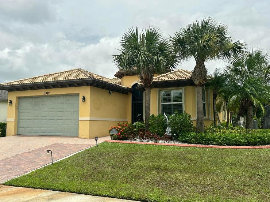 Join Florida's luxury lifestyle in this highly sought after community of Town Park in Tradition. A family oriented development with superior amenities, wide sidewalks, dog parks, tennis courts, kids splash fountains, resort style pool and more. Beautifully designed 3 bed/2/bath home secure with  guarded gates. Features tile floors in main areas/GROUT JUSTED cleaned with an open modern kitchen, granite countertops, stainless steel appliances, and an island. The living room's vaulted ceilings provide a spacious feel, the dedicated office/den provides added versatility or 3rd bedroom. Primary suite boasts two walk-in closets, with an oversized tile shower, duel sinks & separate toilet area. laundry room w/new washer/dryer & sink. Exterior of home just painted 6/1725, new fridge-Jan 2025. The backyard is an oasis with a large roof covered patio and a fenced in back yard. Come enjoy the luxuries of balmy breezes and florida sunshine. The Tradition Development provides a wealth of conveniences such as a Publix grocery store, Target, nail and hair care salons, post office, 10 restaurants, dry cleaners, pharmacy, ice cream/candy shoppe, and more. Along with nearby charter school, Tradition hospital, and parks. Welcome Home!