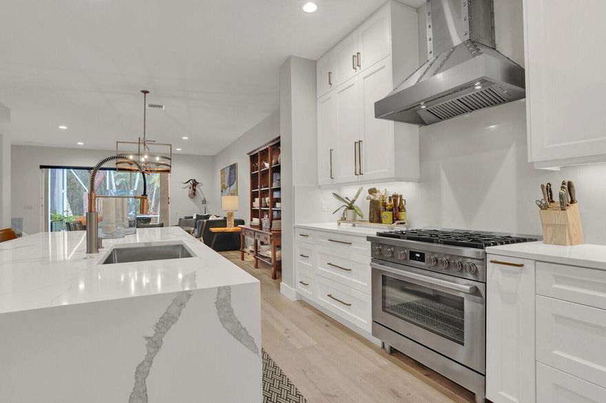 Stunning Renovated townhome in the highly sought after waterfront community of Prosperity Harbor! Prime Location within minutes to the pristine Atlantic Ocean, fine dining and the Gardens Mall.  Renovated in 2022, no details spare.. white oak wood floors throughout the downstairs, luxury vinyl upstairs, Chefs dream kitchen with huge island, custom cabinetry with soft close drawers & builtins, microwave drawer, high end appliances -2022, free standing natural gas range, gas hot water heater, new AC in 2022,  new roof 22-23, all new toilets and vanities in powder and guest bath, modern baseboards, all ultra white interior, hurricane protection complete.. Incredible amount of storage with master bedrooms featuring two large walk-in closets, bedroom two walk-in,