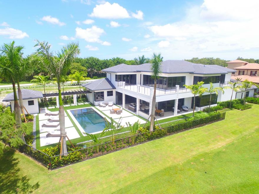 This newly constructed contemporary Blue Cypress estate offers a luxurious lifestyle within the prestigious Palm Beach Polo Golf & Country Club. Exquisitely crafted with interior design and furnishings by Decorator’s Unlimited, this elegant home boasts 4 bedrooms, 5 full bathrooms, 1 half bath and an open concept living/entertaining space blending classic touches with modern state of the art amenities. Enjoy the uninterrupted views of the pristine golf course, tranquil water, and lush 92-acre preserve from almost every room in the home. The open, airy layout is complemented by sophisticated features such as a custom mahogany wood front door, recessed lighting throughout, Italian porcelain tile and hardwood flooring, a professional kitchen with top of the line Miele appliances and a butler's pantry with an 86-bottle wine cooler. Fully retractable family room doors seamlessly blend the indoor/outdoor living space showcasing the covered lanai with outdoor fireplace, summer kitchen, and distinctive saltwater pool & spa. The first floor master suite offers access to the outdoors and features a custom built in bed and wall unit. A floating staircase leads to the second level of the home with 3 additional bedrooms including a VIP suite and access to a wrap-around balcony. Additional highlights of this unique residence include first and second floor laundry rooms, an oversized 4 bay garage with built in storage, Smart home technology, security system, professionally landscaped grounds and an idyllic cul-de-sac location.