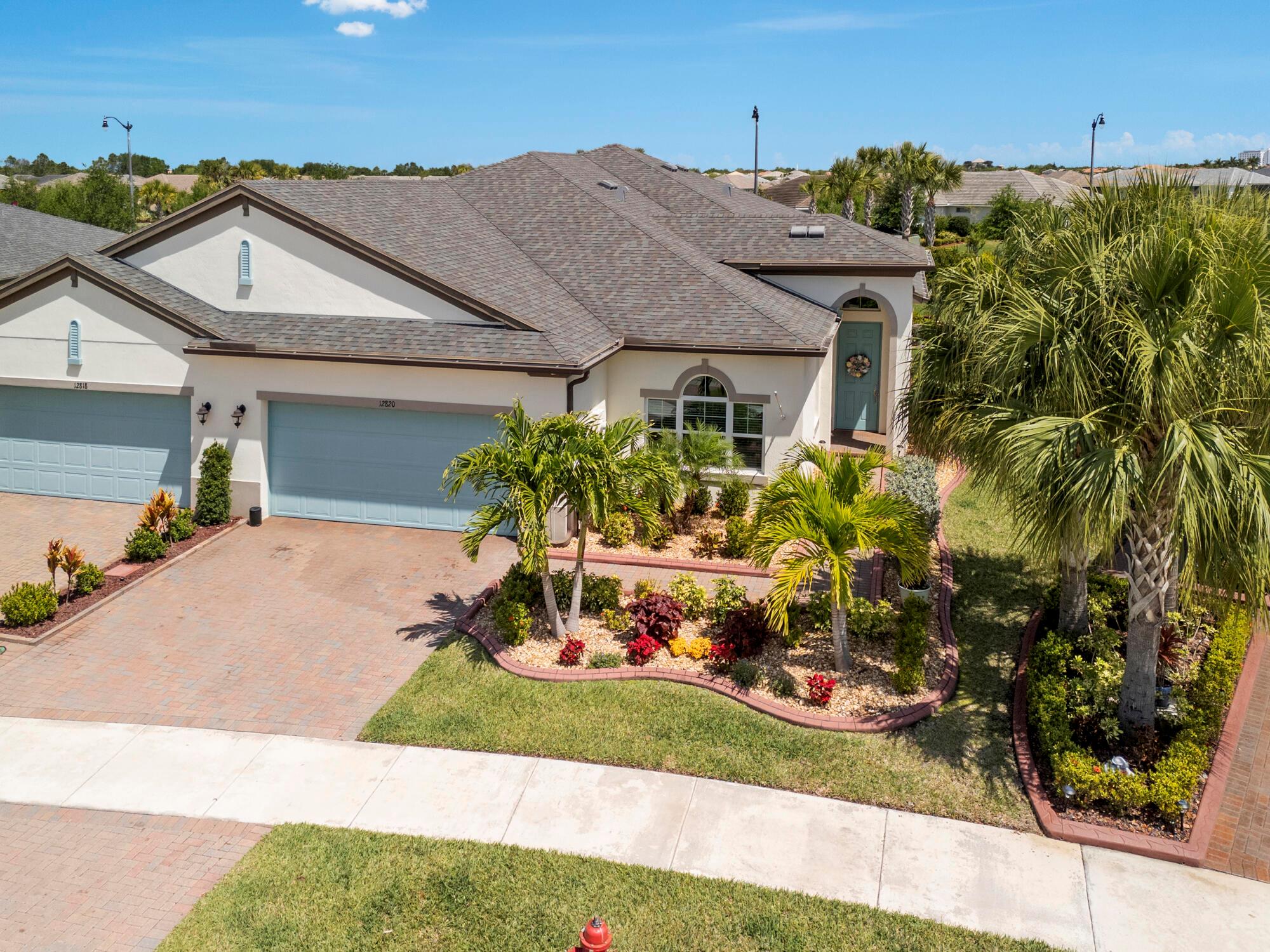 Looking for a turn-key villa offering comfort, modern amenities, and a dynamic lifestyle in a 55+ community? This LakePark villa newly built in 2019 in the highly sought after Tradition development is exceptional! Just under 2,000 interior sq ft, this immaculate villa offers spacious 2 stunning bedrooms , 2 full baths & a den/office. Exquisite features include: a dream kitchen with granite countertops throughout, beautiful tray-ceilings with crown molding, crown molding in bedrooms/den/living room/kitchen, impact windows throughout, impact garage door for added storm protection & safety, screened porch with serene views, tile flooring throughout, and a 2019 roof! Residents enjoy access to two community clubhouses equipped with fitness centers, aerobics and dance studios, multi-purpose