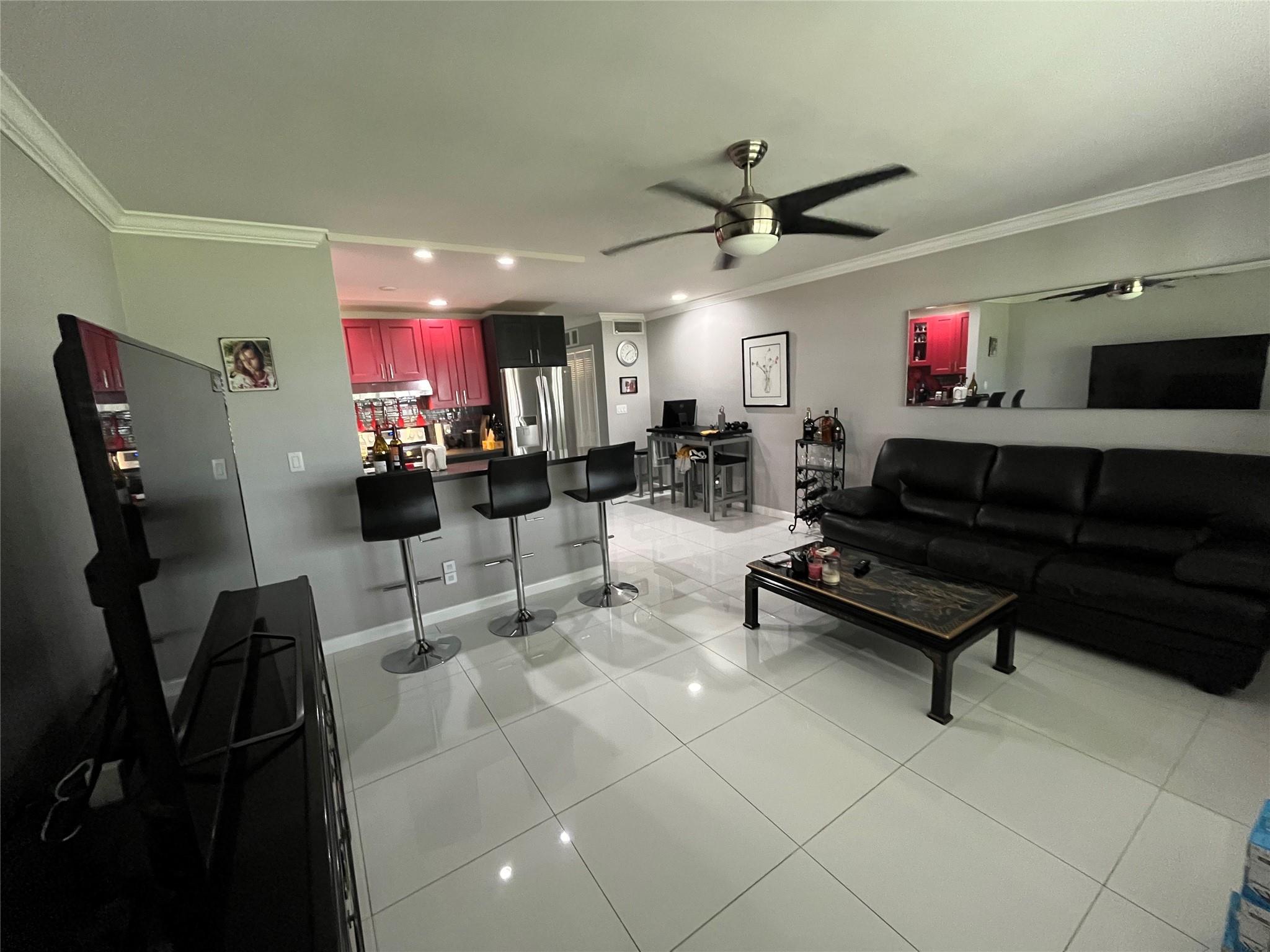 Beautifully renovated ground floor unit with high-end modern decor. Everything is new, including: new kitchen with SS appliances and Quartz counter tops, new bathroom, HW heater, AC, 24x24 ceramic high gloss tiles, crown moldings, LED lighting, California closets, IMPACT WINDOWS. Quiet community, and still close to everything. Walk to restaurants, shopping centers and the BEACH! Furnished if desired, Except for TV in the living room and Bedroom set.