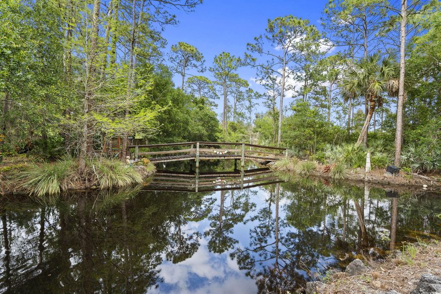 Welcome to your Private Countryside Retreat—where Space, Serenity, and Endless Possibilities come together on 2.05 beautifully expansive acres. This charming 2 Story Rustic Ranch is designed for those who crave room to roam and a lifestyle connected to nature. Whether you're raising a Family, caring for Equestrian animals, or simply enjoy wide-open spaces, this property delivers the freedom you've been looking for. Inside, you'll find warm and inviting features, including rich Oak Cabinetry, gleaming Granite Countertops, and a thoughtfully designed kitchen with a convenient Pass-through window to the oversized screened patio—perfect for effortless indoor-outdoor entertaining. The home is equipped with New Impact Windows and durable Metal roof, offering peace of mind for years to come. The Private Master Suite is tucked away on the second floor, creating a true retreat complete with its own balcony—an ideal spot to take in breathtaking Sunset Views. Start your mornings on the expansive front porch with a cup of coffee as the sun rises over your peaceful property. Step outside and experience everything this property has to offer. Spend warm days enjoying the east/west exposed pool, unwind in the hot tub after a long day, or host unforgettable gatherings under the large pavilion featuring countertop seating, water, and power—ready to be transformed into your dream outdoor kitchen. From birthday parties to weekend BBQs, this space was made for making memories. For the outdoor enthusiast, the stocked pond offers the perfect escape for fishing, while the expansive acreage provides ample room for animals, recreation, or even a home-based business. An existing 1,100 sq ft CBS structure—currently dog kennels—offers incredible flexibility and can easily be repurposed into an in-law suite, home office, stable, or garage for your toys. The rear property is fenced in paddocks for your furry friends. With a little vision and finishing touches, this One-of-a-Kind property can become your Forever Homestead—a place where your lifestyle dreams truly come to life.