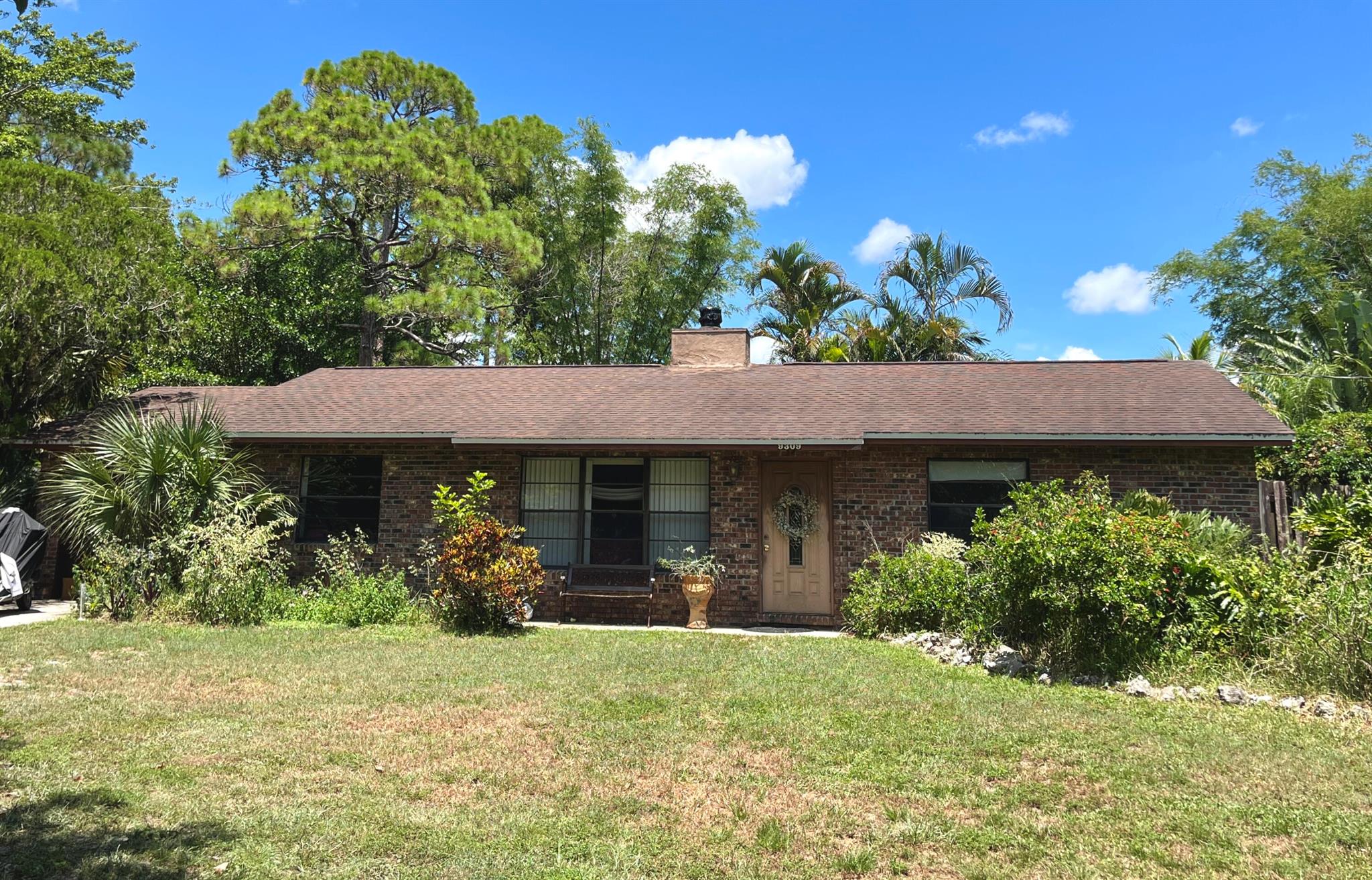 Discover the charm of country-style living with city convenience in this unique property! This solid brick home sits on a full acre in a quiet, no-HOA community where you'll find golf carts, ATVs, boats, and even peacocks roaming the neighborhood. Equestrian-friendly and full of character, the property offers plenty of potential for those looking to make it their own. The home itself is ready for updates, but features a well-maintained fiberglass pool and a cozy, well-kept wood-burning fireplace perfect for cooler evenings. The large lot provides space for gardening, outdoor activities, or future projects. Just minutes from the beach, shopping, dining, and everyday conveniences/ commutes like the Turnpike, it's an ideal opportunity for buyers seeking land, freedom, and lifestyle.