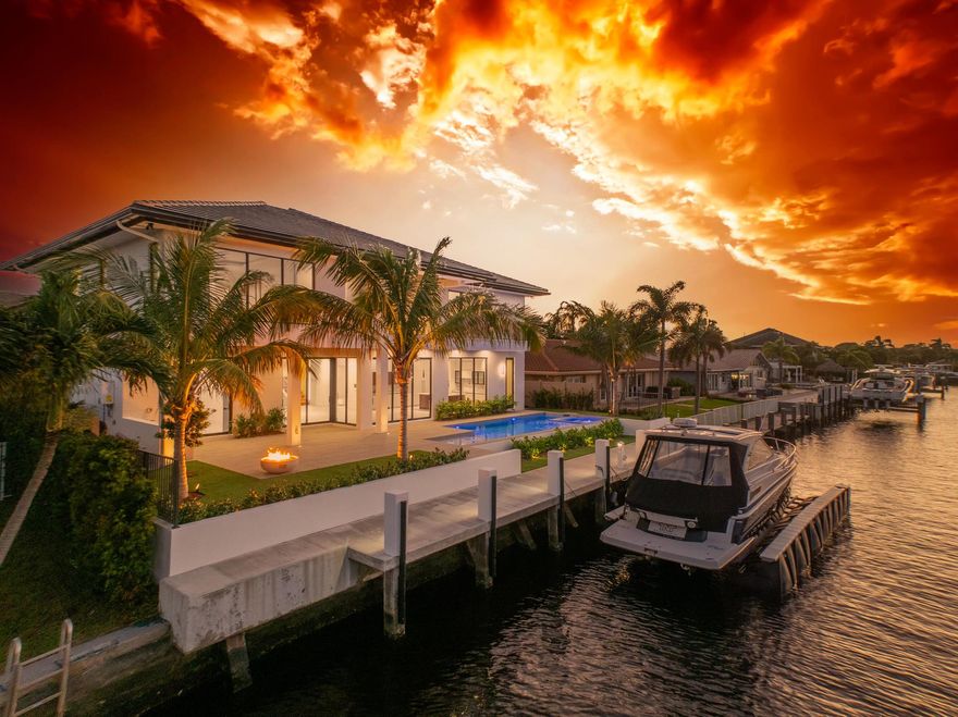 A modern masterpiece, seamlessly blending sleek architectural design, luxurious amenities, andcutting-edge technology to offer an exceptional South Florida lifestyle. Nestled minutes fromHillsboro and Boca Inlets, this waterfront estate provides immediate ocean access, ideal foryachting enthusiasts with its 80-foot yacht dock complete with bumpers, cleats, Shore PowerPedestal, and water supply, all secured by robust concrete pilings and evening lighting.The home's custom architectural design is captivating, combining tropical landscaping withexpansive 10-foot PGT impact glass doors that welcome natural light while connecting indoorand outdoor spaces. An entertainer's paradise, the exterior offers a spacious loggia with asummer kitchen, a gas-powered concrete fire bowl