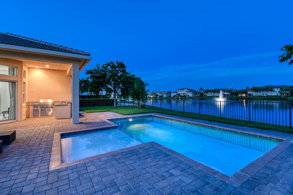 Fantastic Oversized 4Bed/4Bath Single Level Pool Home. Separate Den, Family, Living & Dining Rooms. Modern Chefs Kitchen Includes; Quartz Counter Tops, Marble Tile Backsplash, Top Notch Appliances & Hooded Stove Top. Scenic Windows & Doors Provide Amazing Pool/Lake & Golf Course Views. Large Primary Bedroom has a Custom Built His/Hers Closet + a Spa-Like Bathroom. Ensuite 2nd/3rd/4th Bedrooms have walk-In Closets. Interior & Exterior Features Include; Crown Molding, Coffered Ceilings, Reverse Osmosis Water Treatment, Tile & Plank Wood Floors, Huge Fenced-In Back Yard & Extended Paver Patio/Lanai has a Built-In Summer Kitchen, Perfect for Entertaining. 3 Car Garage. Fabulous Resort Country Club Amenities, Signature Greg Norman Golf Course, Minutes to the Beach, Downtown & Airport.
