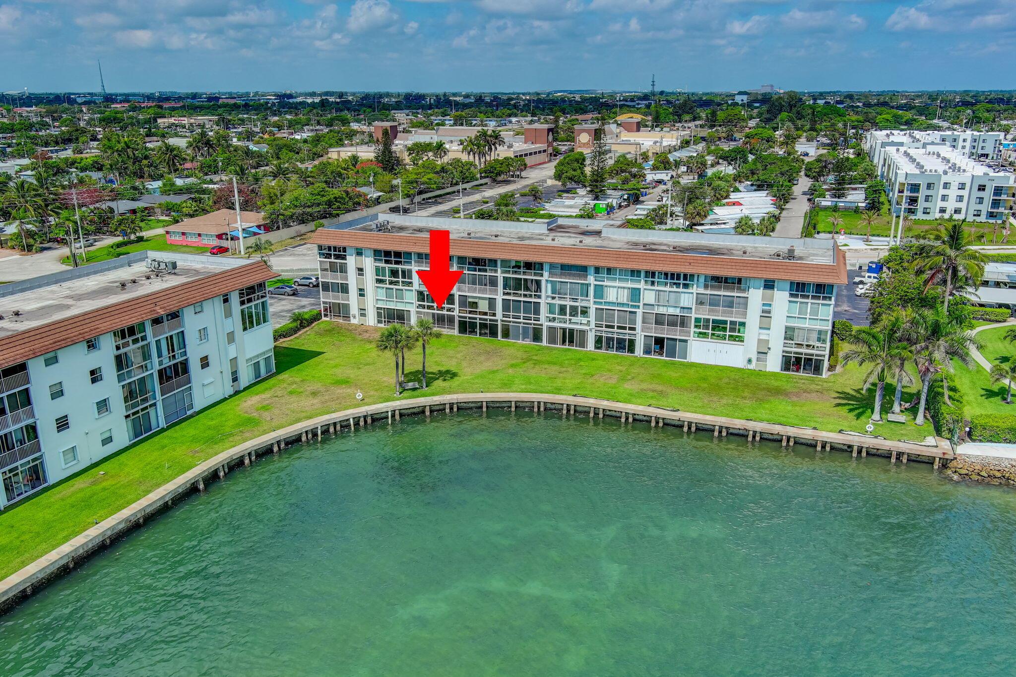 Enjoy endless views of the Intracoastal from your living room, kitchen and screened-in patio. Located on the 1st floor of a gated community, this unit offers a perfect blend of comfort and convenience. Sparkling waterfront pool with stunning Intracoastal views! Laundry Room on every floor of the building. Minutes from local marinas, Philip Foster Park and Peanut Island. Enjoy easy access to the beach, dining, shopping, and highways. (Hurricane Accordion Shutters ordered, to be installed by August)