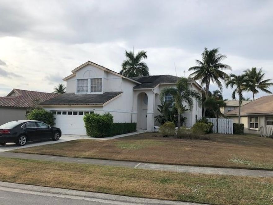 CBS 4/3 Single Family home with Pool and Fully Fenced Rear yard.  Dark Wood  cabinets in kitchen overlooking family room.  Vaulted ceiling in Living Room.  One bedroom on ground floor, 3 Bedrooms up with remodeld Master bathroom with dual sinks and Roman Tub.  Master has walk-in closets and extra bonus room.  Wood plank laminate floors.  Located in The Estates/ Windchime Lakes, a gated community in west Boynton Beach, offers low HOA fees and excellent schools