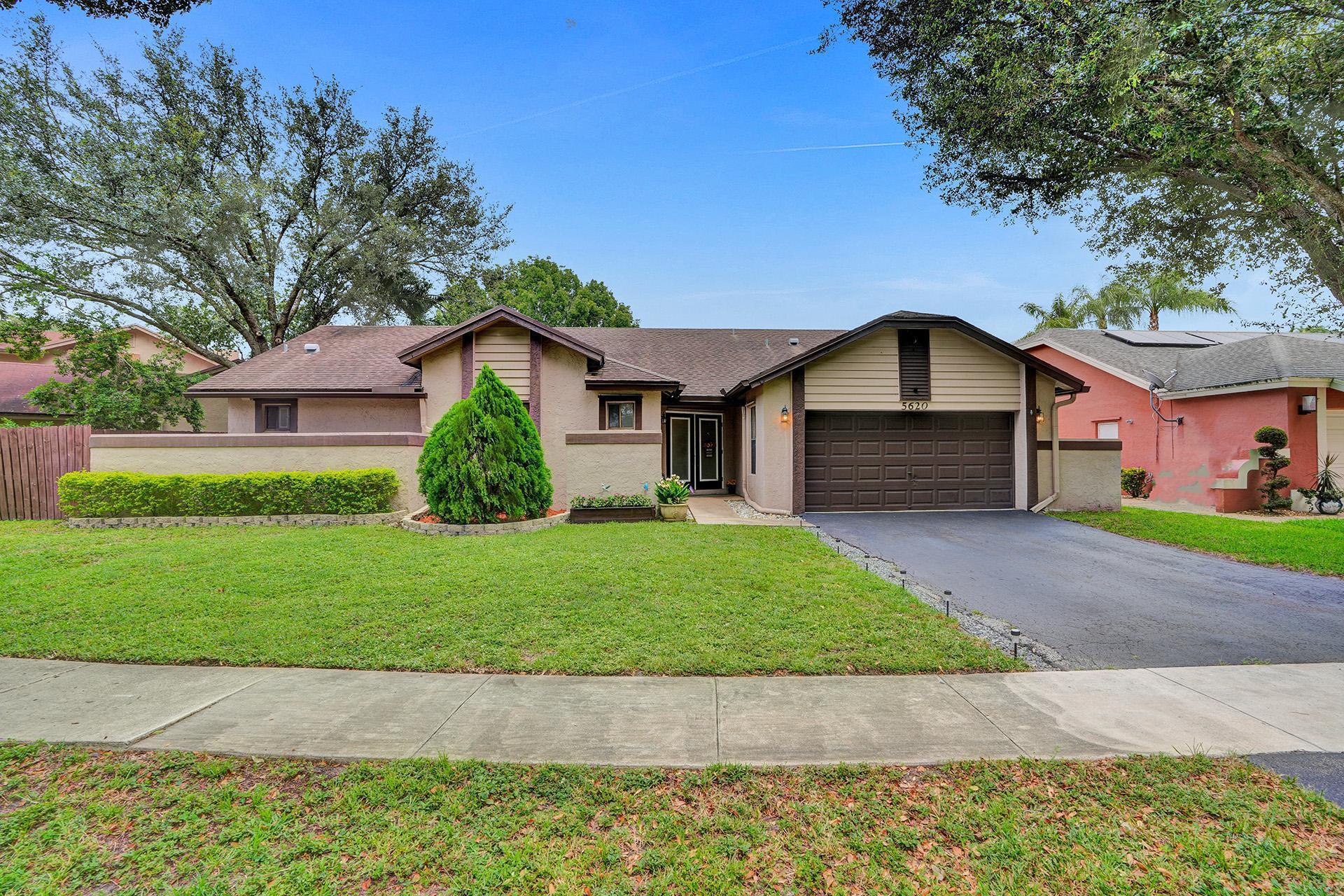 Welcome to your future home in the highly sought-after Country Address. This pristine 4-bed, 3-bath residence offers renovated tile floors throughout and ample space for growing families. Experience the open ambiance with high ceilings and a 3-way split floor plan ensuring privacy and convenience. The expansive layout seamlessly blends indoor and outdoor spaces, including a screened enclosure, perfect for entertaining. Enjoy a private yard with a large saltwater pool, and 60ft of waterfront views. The renovated kitchen features granite countertops, stainless steel appliances, and new cabinetry. The fenced side of this home will accommodate your boat or RV, or a garden. This Home is steps away from Ellie Kozak Park providing a shaded playground, and open fields for your family's enjoyment.