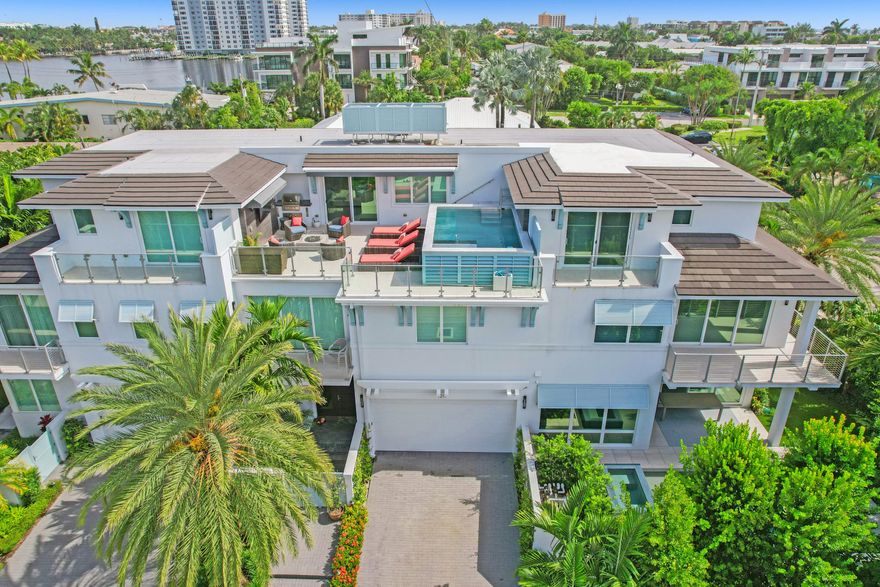 Stunning turn-key, contemporary townhouse in the heart of Delray's sought after Seagate neighborhood. close to pristine beaches, restaurants and shopping. This gorgeous, property built in 2018 impresses with 4 spacious bedroom suites, a chef's kitchen, backyard with a summer kitchen, an elevator, 2 wet bars and a morning-bar, a clubroom on the third floor and best of all, an awe-inspiring roof top terrace, complete with summer kitchen, entertainment system and a refreshing private pool with spa feature. The home is conveniently fitted with a Sonos surround sound, Control4 and water softener systems and more. The spacious, two car garage has extra high ceilings allowing for lifts. No cost or effort was spared in making this the perfect Delray Beach residence.
