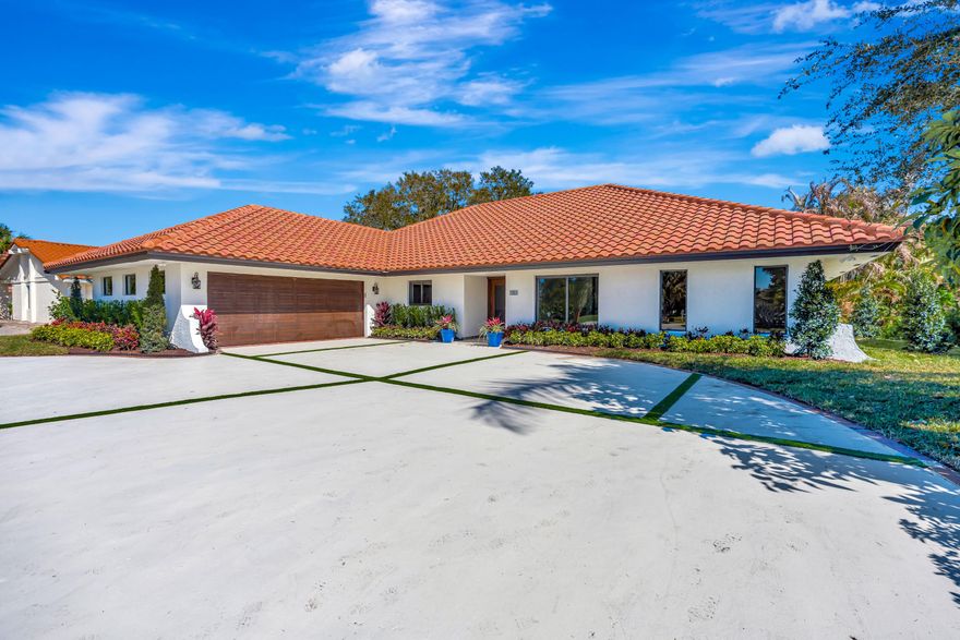 Redesigned by East Ocean Living and Stuart architect Joseph P. McCarty, this stunning CBS home combines luxurious craftsmanship with modern elegance. Features include a gourmet kitchen with professional style appliances, a 48-inch gas stove, quartz countertops, and spacious walk-in pantry. Soaring vaulted ceilings create an open, airy feel. The primary suite offers a spa-inspired bath and custom walk-in closet. Warm wood-tone floors, designer tiles, and gold fixtures add sophistication throughout. Impact windows and doors, new HVAC, and warranties provide peace of mind. Step outside to a very secluded landscaped  yard with a new pool, patio, breezes off the River and private outdoor living space. Located in the prestigious gated Yacht & Country Club community, just minutes from beaches, fine dining, private airport, Downtown Stuart!  NO MEMBERSHIP REQUIRED!