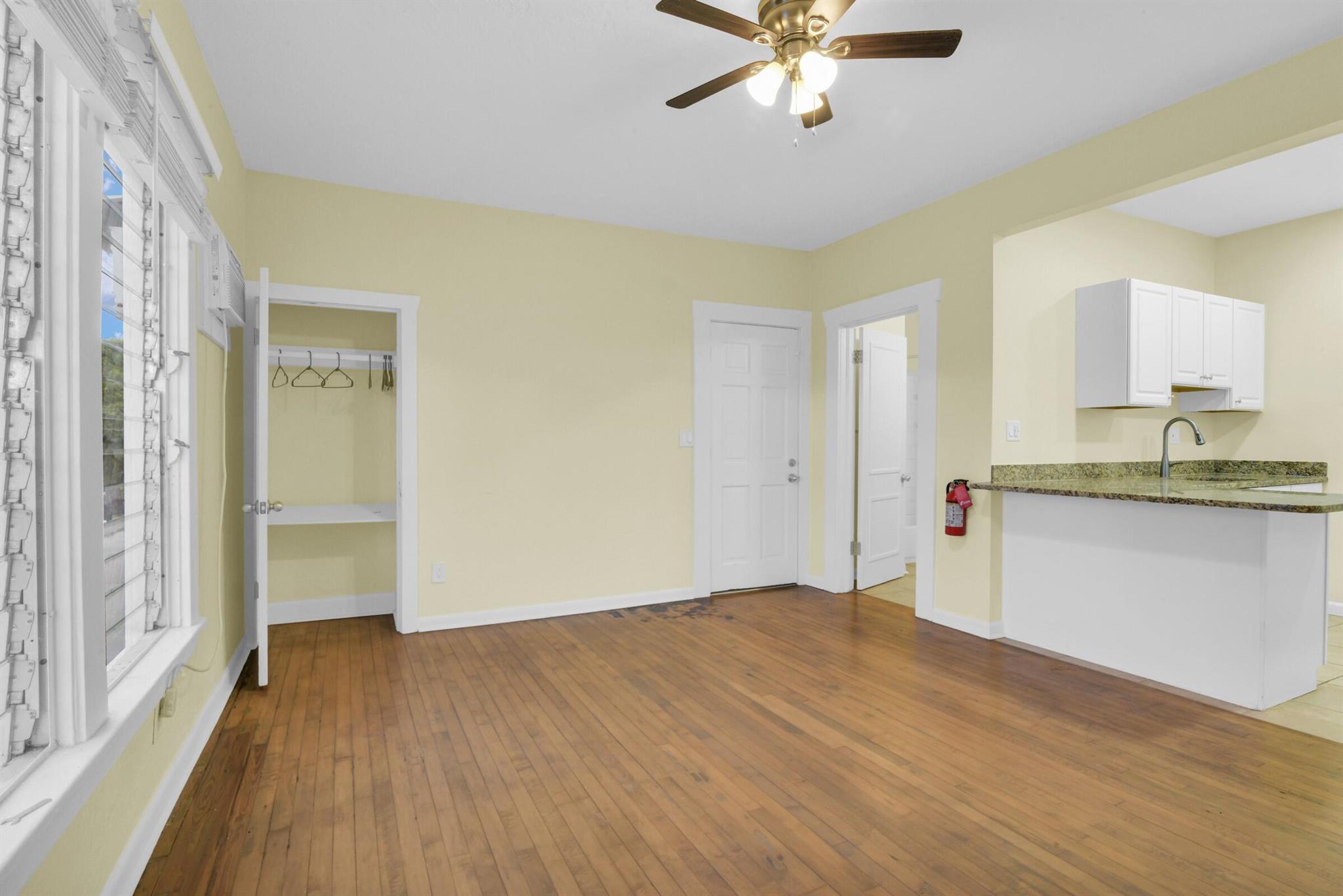 Discover this beautifully updated 1-bedroom, 1-bathroom unit in a charming Lake Worth Beach building. This spacious rental features gleaming wood floors, fresh paint, and an abundance of natural light throughout. The kitchen is equipped with granite countertops, white cabinetry, and essential appliances. Enjoy a comfortable living space with ceiling fans and a cozy bedroom with ample closet space. The modern bathroom is designed with clean, stylish fixtures. This unit offers a perfect blend of convenience and comfort.