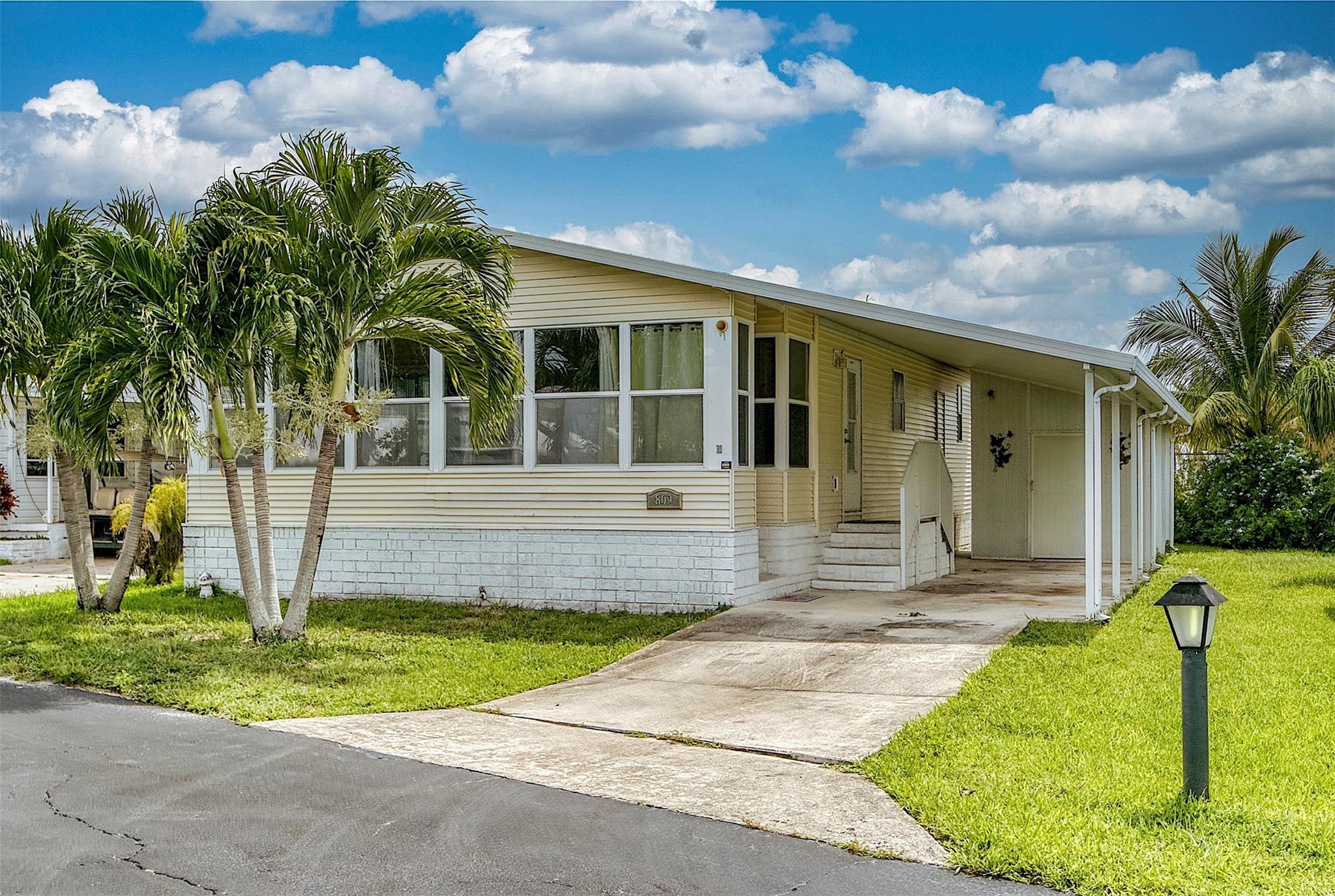 MOTIVATED SELLER!! This 2003, 40-foot double wide mobile home is located in the vibrant 55+ community of Golf View Estates, where residents enjoy resort-style amenities including two swimming pools, hot tub, sun deck, covered patio seating, private clubhouse, fitness center, men’s and women’s saunas, and shuffleboard, along with regular social gatherings and special events. The home features 2 bedrooms, 2 bathrooms, and a spacious Florida Room. The open floor plan offers a seamless flow between living, dining, and kitchen areas, enhanced by luxury vinyl plank flooring, central A/C, and abundant natural light. Additional features include a washer and dryer, storage shed, and covered parking—all adding to the comfort and convenience of this move-in-ready home.
