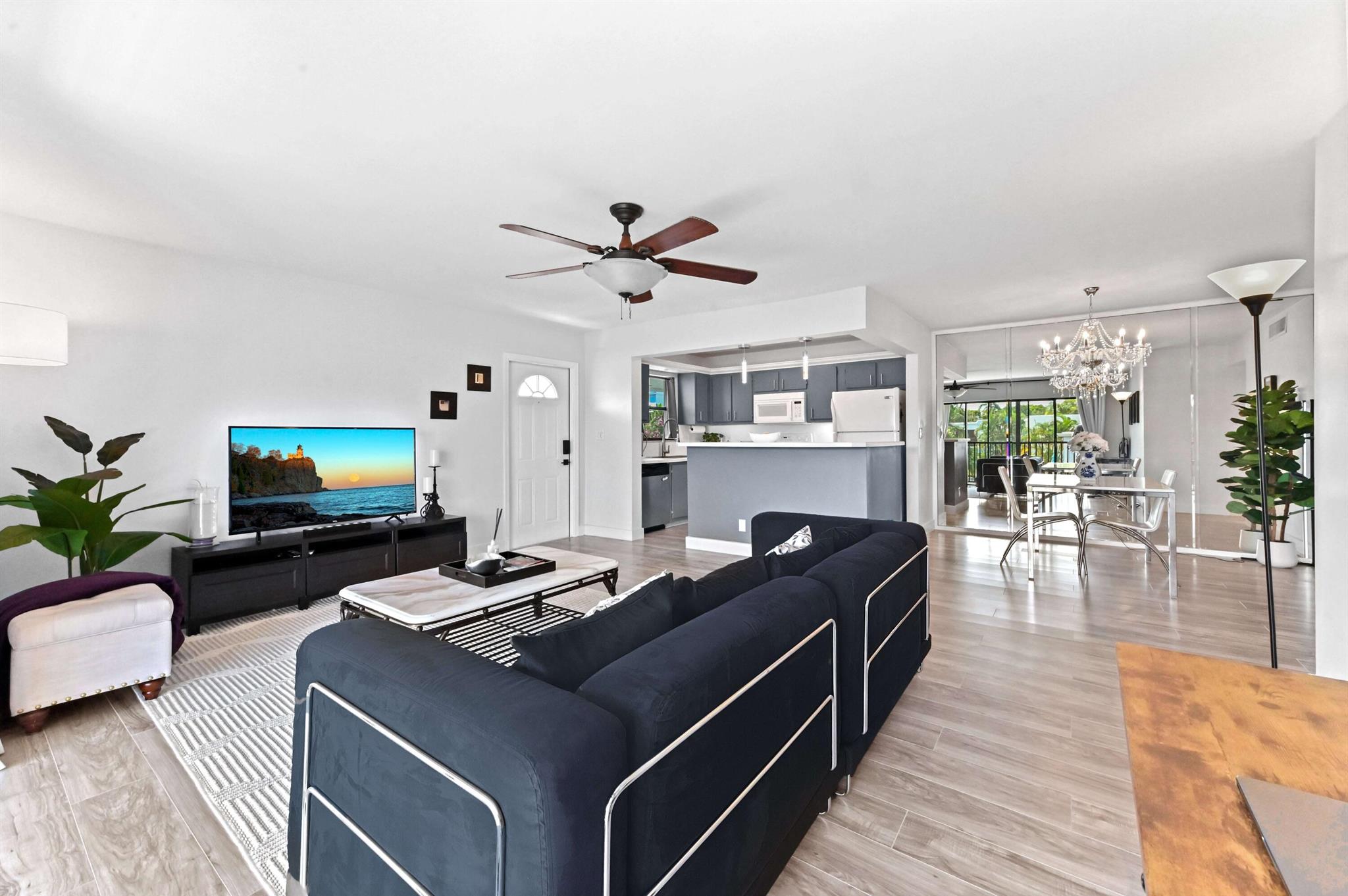 Modern 2-bedroom, 2-bath condo located in one of the most desirable units in the community. Enjoy a true Florida lifestyle with peace and privacy from your spacious and stylish living area, featuring a rare second-floor, unobstructed view of the tropical garden and sparkling pool.* Best view in the community - enjoy serene mornings and sunsets overlooking the pool, not the parking lot* Sun-filled living area with oversized 3-panel windows bringing in natural light all day* Modern upgrades throughout: smooth ceilings, tall baseboards, new flooring, and an elegantly remodeled master bathroom