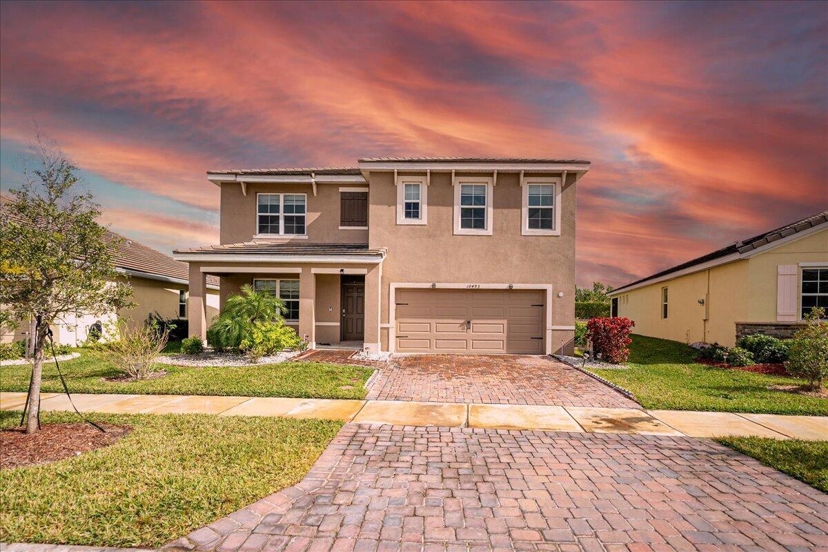 Discover the perfect blend of comfort, style, and convenience in this spacious 5-bedroom, 3-bathroom home located in the gated community of The Estates at Tradition. Built in 2021, this modern two-story home features a bright open floor plan with a gourmet kitchen, stainless steel appliances, granite countertops, and a large island perfect for entertaining. Enjoy the flexibility of a first-floor guest bedroom and full bath, plus a generous upstairs loft and private home office space. The primary suite boasts dual walk-in closets and a luxurious en-suite bath. Step outside to a covered patio and fully fenced backyard--ideal for family gatherings or peaceful evenings. Located in one of Port St. Lucie's most desirable neighborhoods, this home offers access to beautiful walking trails, parks,