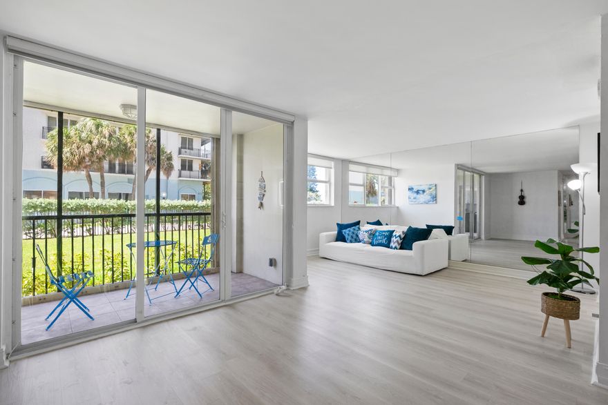 Welcome to easy first-floor living in this bright, open-concept condo in Port De Mer's coveted oceanside 1239 building. Light plank flooring & soft neutral walls give this unit a clean, modern coastal feel. Enjoy a peek of the ocean & beautiful garden view from the screened patio. Original second bedroom can easily be restored, converting the unit back to a full 2/2. Kitchen features stainless steel appliances, window for natural light & patio access. Spacious primary bedroom, two large walk-in closets & updated bathroom vanities & lighting. Port De Mer is a gated, pet-friendly community w/ two pools, BBQ area, garage parking, & extra storage. The building completed all structural requirements & upgraded lobbies & elevators, owner paid assessments. Steps to Deerfield Pier, & restaurants.