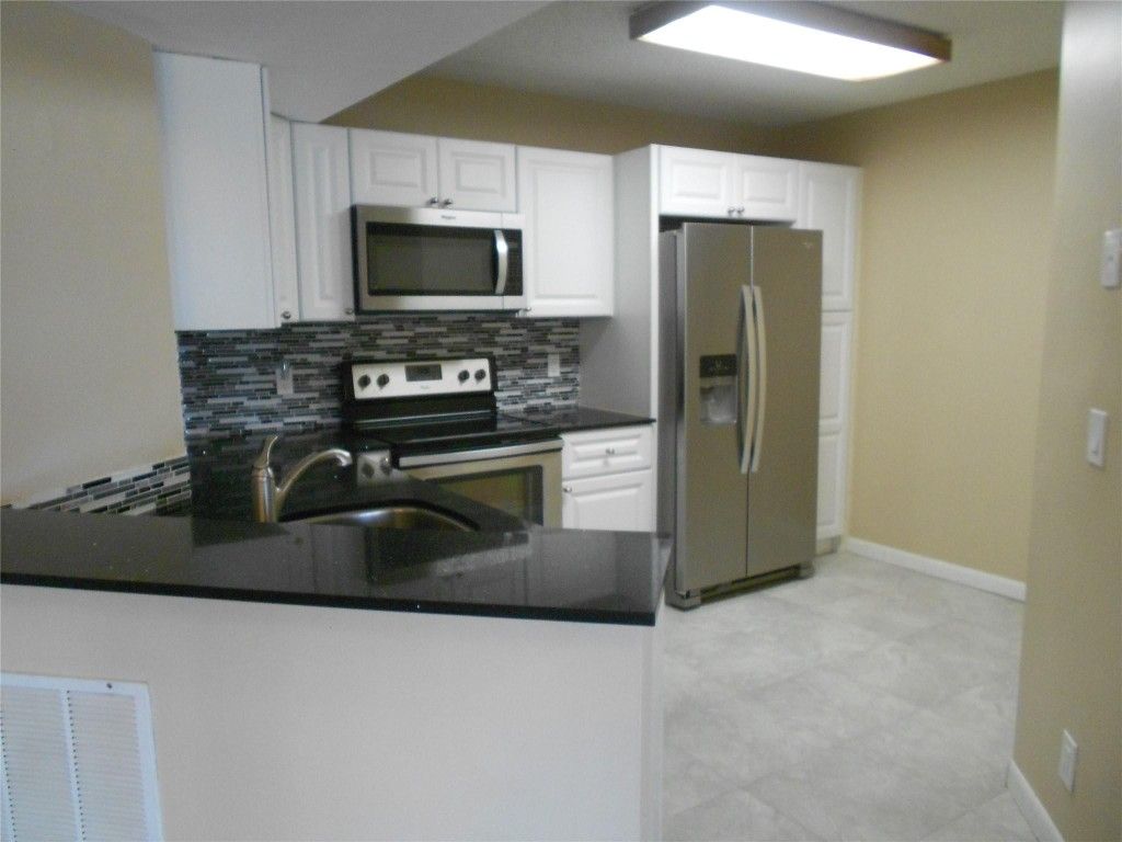 Photo of 8977 Wiles Road #2-203, Coral Springs, FL 33066 (MLS # F10507914)