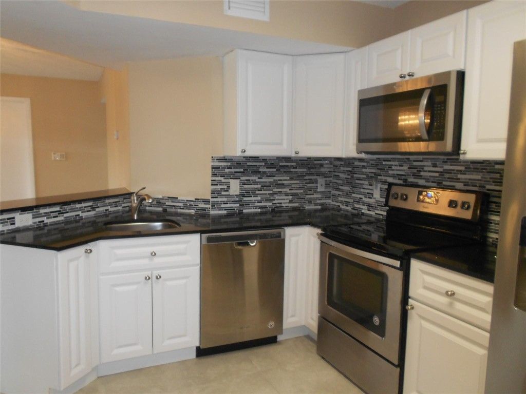 Photo of 8977 Wiles Road #2-203, Coral Springs, FL 33066 (MLS # F10507914)