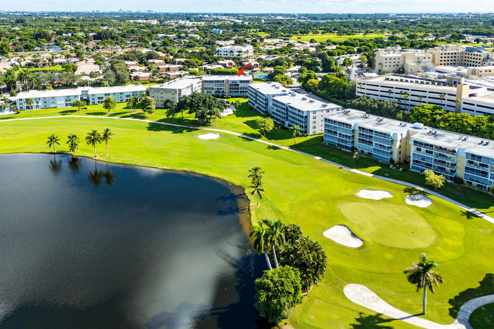 Experience serene living in this inviting 3-bedroom end-unit condo, perfectly positioned to offer peaceful fairway and water views. Enjoy the privacy and tranquility of this prime location in the coveted Atlantis community. The living areas are designed for comfort and style, with easy-to-maintain tile flooring throughout. Open-concept living connects the dining, family, and living rooms, allowing natural light to flow effortlessly while showcasing stunning fairway views. The updated kitchen is a bright, functional space with solid white cabinets, newer appliances, and a breakfast counter perfect for casual meals. A custom bar area extends the kitchen, providing additional space for entertaining guests with ease...