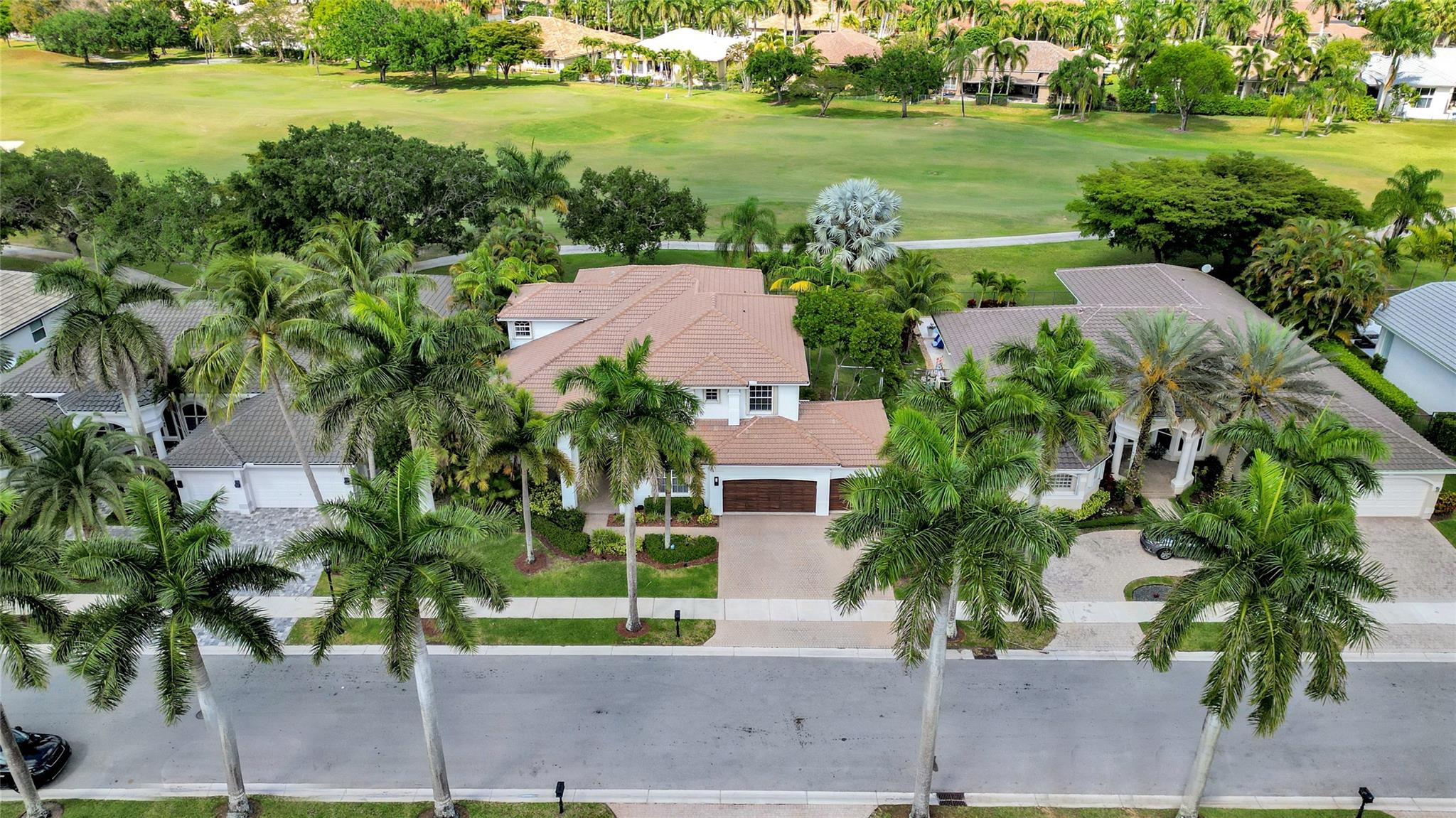 Breathtaking golf course views! The crown jewel of this stunning Weston Hills Country Club estate! Perfectly placed on an oversized lot with no neighbors behind, this home offers unmatched privacy and a front-row seat to Florida’s most serene fairways. Renovated travertine pool deck framed by lush landscaping, ideal for sun-filled afternoons or entertaining under the stars. Inside, 6 bedrooms (2 conveniently on the main floor) plus a versatile bonus room give flexibility for family, guests, or a private office. The primary suite is a retreat, with its own balcony overlooking the pool and endless greens. A gourmet kitchen with granite counters, stainless appliances, elegant wood floors, and a professionally organized garage complete the picture, where luxury, comfort, and lifestyle meet.
