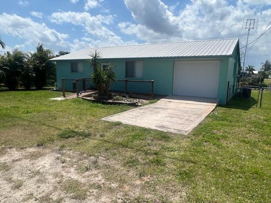 This adorable home is completely move-in ready! This 2-bedroom, 1½-bath CBS home with a durable metal roof overlooks a canal with direct access to Lake Okeechobee, making it a dream for boating and fishing enthusiasts.The well-maintained interior features an updated kitchen, new flooring throughout, and refreshed bathrooms, offering both comfort and style. Outside, you’ll find a full seawall, covered boat slip, concrete patio, and a small shed for extra storage.Perfect as a winter retreat, weekend getaway, or seasonal rental investment — enjoy waterfront living with all the essentials already in place!