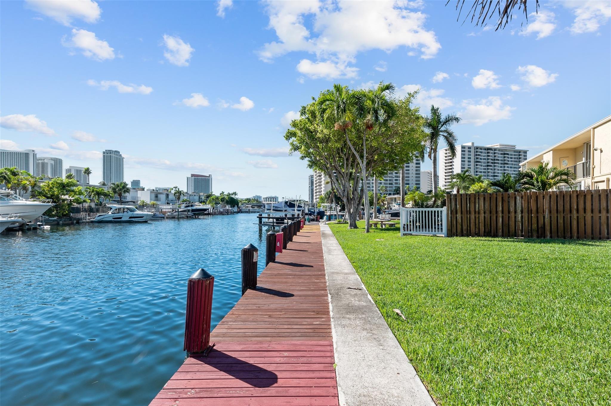 Beautifully updated 3 bedroom, 2.5 bathroom townhome with pristine water views from your own private dock. This 2 story unit is very spacious. The updated kitchen features an eat in kitchen, large cooking island, updated stainless steel appliances. Tile and laminate flooring throughout. Large master bedroom with a walk in closet with closet system and an amazing water view. Private patio with grill perfect for entertaining friends and family. Fully furnished. Full size washer and dryer in the unit. This unit comes with 2 parking spaces. Community features 2 tennis courts, heated pool, party room with kitchen. Plenty of guest parking available. Close to great shopping centers, airports, Gulf Stream Racetrack, Aventura Mall, and amazing restaurants.