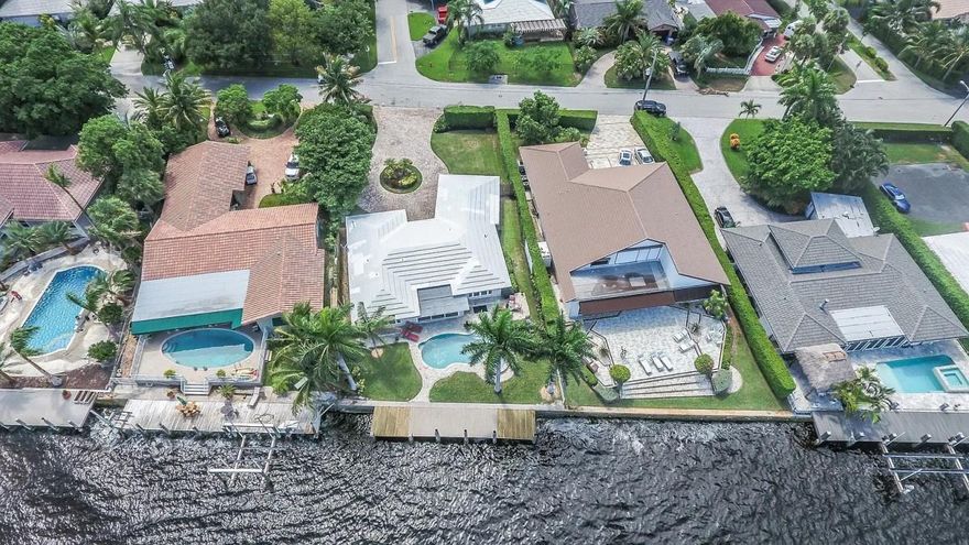 Charming 3 bedroom 3 bathroom ranch home right on the Intracoastal Waterway with a 27K LBS elevator boat lift.