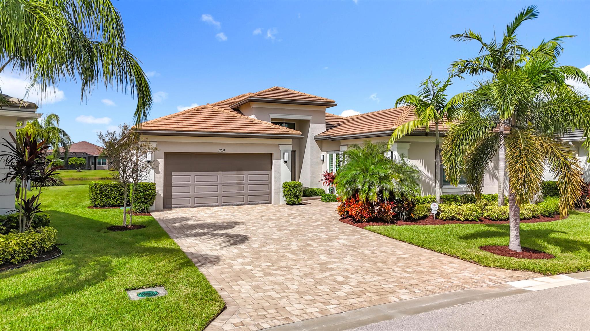 Lake Views! Popular Caroline Model in Valencia Cay in Riverland - 55+ Active Adult Community.2,580 SF open floor plan features 2 bedrooms, 2.5 baths, a den/game room (or 3rd bedroom), and a 3-car garage. Many upgrades include custom cabinets, quartz countertops, polished tile, custom window treatments, a seamless glass shower enclosure in the master bath, Cat 5 impact windows and doors, a monitored security system, tile roof, 8-ft garage doors, and an extended paver driveway.The outdoor water oasis includes an extended screened lanai and kitchen & grill rough-in.Valencia Cay in Riverland is known for top-tier amenities including resort-style pools, restaurants, River Fresh Cafe, fitness center, pickleball, Arts & Culture Center, and city parks. The Town Center Publix grocery store