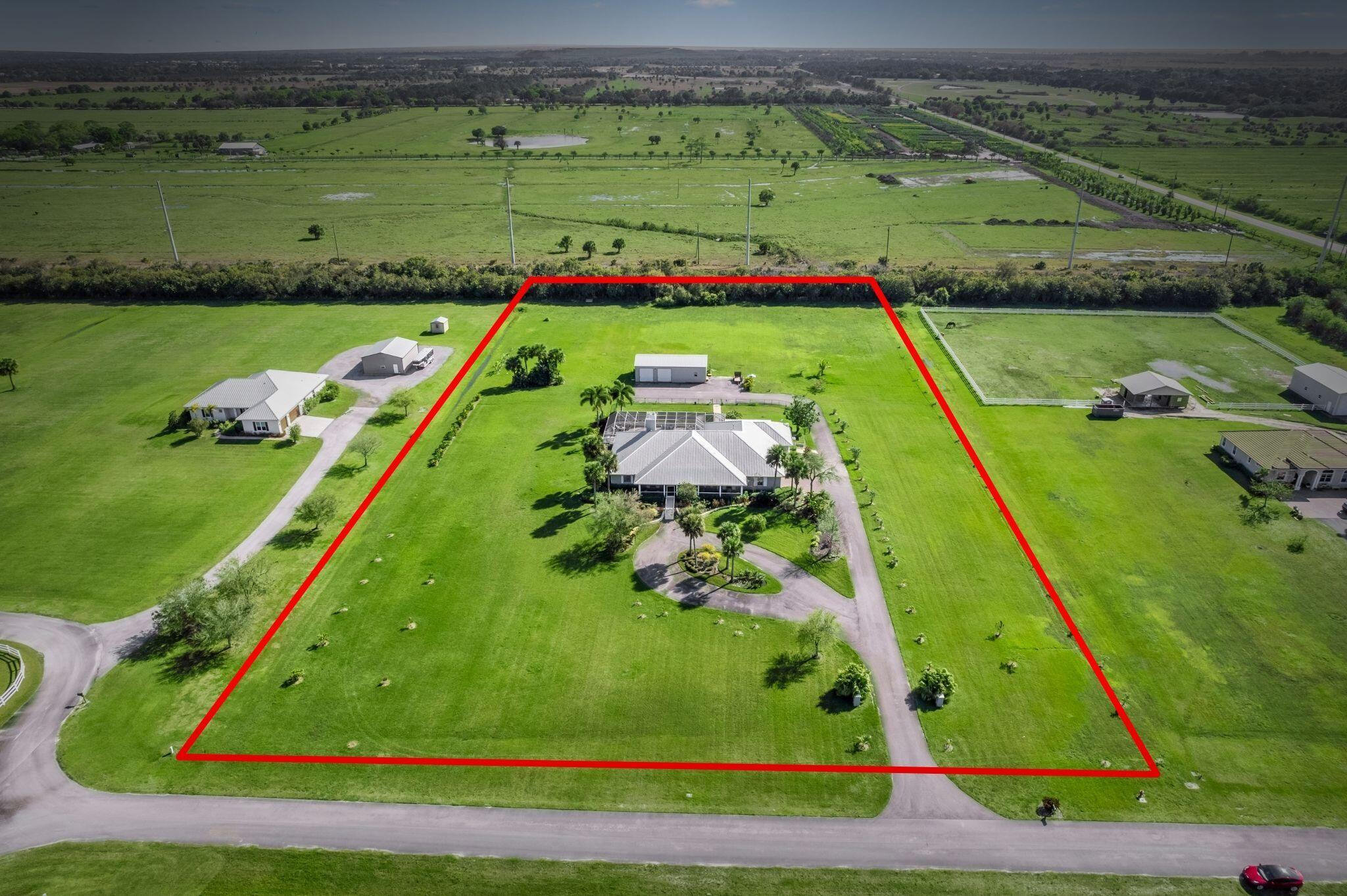 Peace and enjoyment are sure to follow those that enter this almost 5 acre equestrian estate. This Luxurious Pool residence features 6 beds, 5 baths just shy of 5,000 Sq-Ft Joined by a fully equipped 2 bed in-law suite with its own kitchen-patio-laundry-bath to accommodate a large family. Tastefully furnished and remodeled with luxury finishes step inside to an open floor-plan designed with a large gourmet kitchen, induction cooktop, soaring ceilings, custom closets, quartz counters, formal dining, impact window/doors, wood tile, fresh paint, huge air conditioned Florida room/Game room and much more. Outside is paradise all surrounded by fruit trees with a huge screen enclosure overlooking the heated pool with serene views of this secluded community. Negotiable to separate in-law suite.
