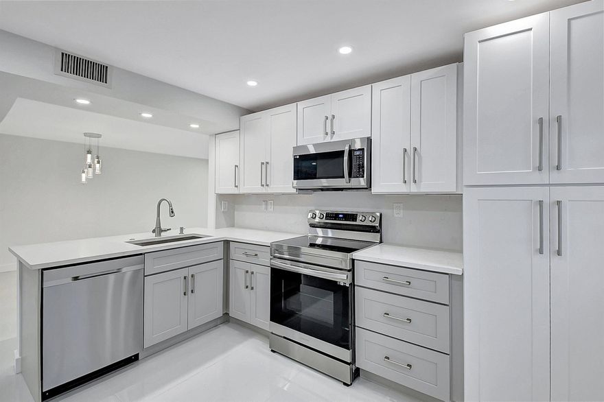 Under construction and fully remodeled, this ground-floor corner unit in the sought-after Lakes of Delray offers stunning lake views and easy access--just park and walk right in! The open-concept layout features a spacious eat-in kitchen with white cabinetry and a convenient pass-through. The owner's suite includes ample closet space and an en suite bath with a step-in shower. Enjoy breathtaking views from the screened patio. Lakes of Delray is an active 55+ community offering resort-style amenities--clubhouse, multiple pools, spas, tennis, pickleball, and endless social activities.