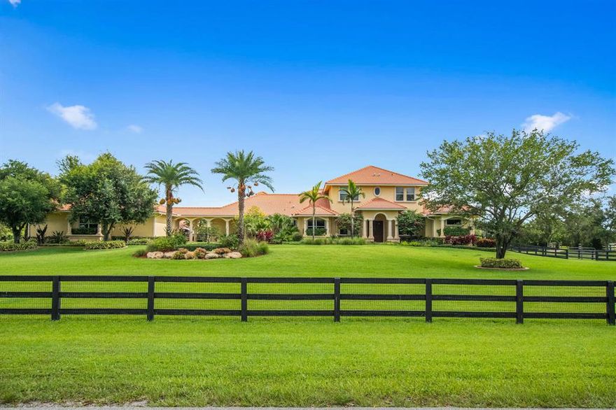 Exceptional equestrian compound sitting on 5+ acres in the exclusive and gated community of Palm Beach Point. The interior of this elegant home has four bedrooms, plus an office and a loft, fireplace, impact windows throughout, marble & wood flooring, a 2+ car attach and an oversized 3 car detached garage. In addition, the gourmet kitchen features dual farm house sinks, double ovens, 2 dishwashers, and a warming drawer. The exterior boosts an expansive patio and pool area with phantom screens, Old Chicago pavers, hot tub & spacious summer kitchen. The private 8 stall center aisle barn features 12x12 rubber matted stalls, fly spray system, studio apartment with full bath, feed room, AC tack room, laundry room, ½ bath , 2 wash stalls, large sand arena and 8 paddocks. The property is lushly landscaped, gated, fully fenced and is a convenient & short hack to Palm Beach International Equestrian Center.