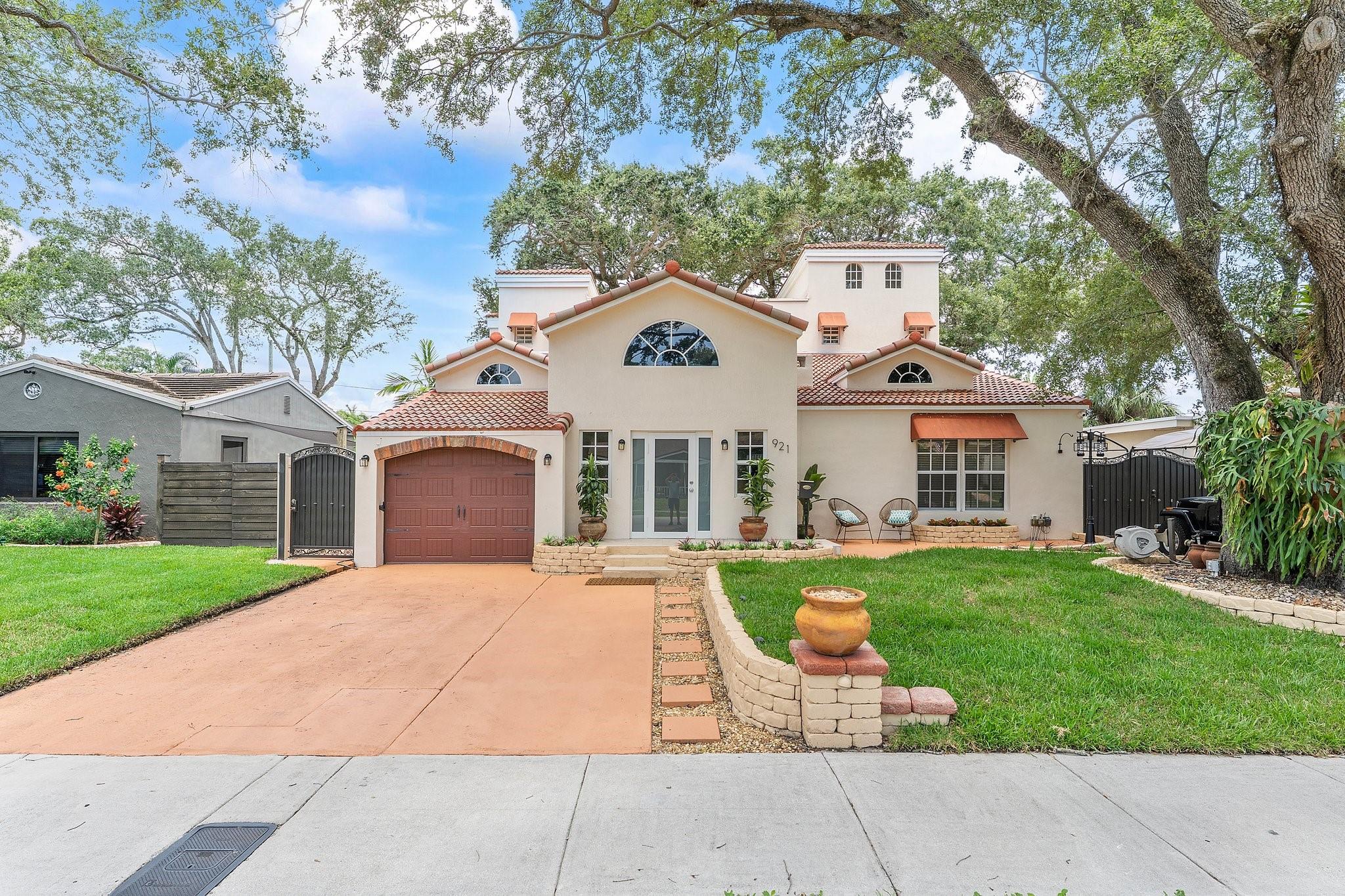 Experience the essence of waterfront living with 60 feet of ocean-access frontage, nestled beneath a canopy of majestic oaks. This six-bedroom, four-bath residence offers a harmonious blend of elegance and comfort, featuring soaring ceilings, a cozy fireplace, and oversized porcelain tile throughout the entire space. Expansive windows offer views of the serene backyard, featuring a waterside pavilion, a spacious entertaining deck, and a rooftop perch. With impact windows, zoned A/C, and updated roofing (2024 front, 2019 rear), this is a rare and tranquil retreat.