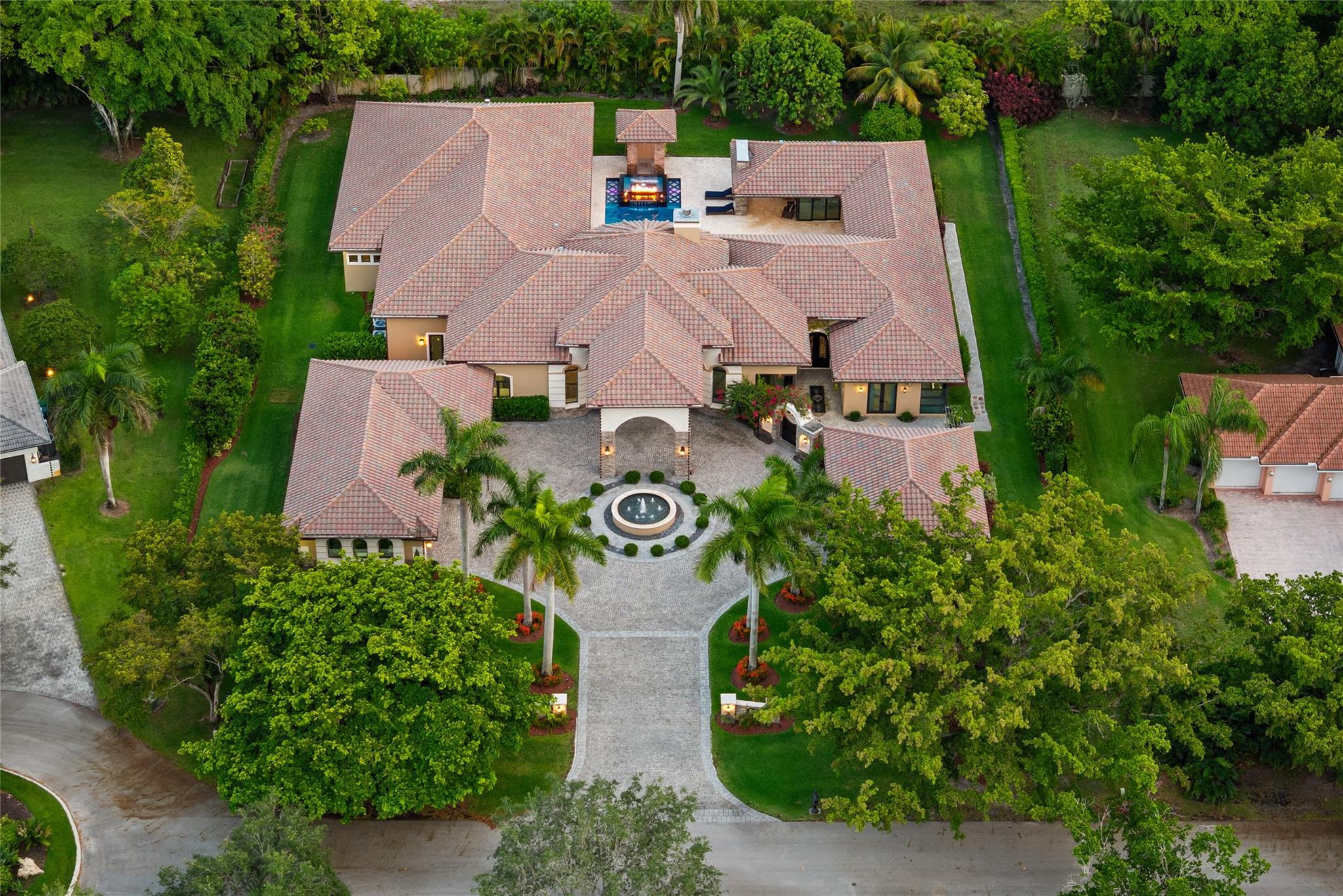 Imported Italian Stone Driveway & Porte Cochere Greets You To This 2016 Custom Smart Home w/7,100 SqFt Mediterranean Mansion w/5 Bedrooms, 5 Baths, 2 Half Baths + Gym + Gameroom + Office, Wine Cellar & Backlit Stone Counter Bar & Outdoor Resort w/5 Fire Features & 5 Waterfalls Surrounding An Outdoor Kitchen & Woodfired Oven, Exterior Living & Dining w/Wall Fountains. Private Guest House w/Full Kitchen & Living Room & Ensuite Bath w/Generator. Soaring Coffered Ceilings & Mediterranean Wooden Arches Guide You Throughout The Home. Impact Windows & Doors Where Every Room Has A Pool & Courtyard View Or Water Feature. All Beds Have Ensuite Baths w/Backlit Counters, 6-Car Garage w/A/C & Hydraulic Lift For Car Collectors. Meticulous Landscaping w/Fruit Trees All On 1 Acre! Guard Gated Community.