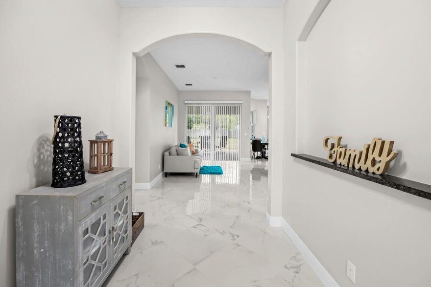 Experience refined Florida living in this elegant 2020 CBS contemporary residence set on a generous 0.29-acre lot in a peaceful Port St. Lucie neighborhood with no HOA. This impeccably maintained single-story home offers 4 bedrooms, 3 baths, and 2,536 sq ft of thoughtfully designed living space with a desirable split-bedroom layout. The open-concept interior features ceramic tile flooring, a chef-inspired kitchen and breakfast area, and expansive living and family spaces ideal for entertaining. The primary suite is a private retreat with dual vanities, a spa tub, and a separate shower. Outdoors, enjoy a fenced backyard with fruit trees, a covered patio, garden views, and ample room for a pool. Enhanced by a metal roof, full panel shutters, a security system, and a 2-car garage.