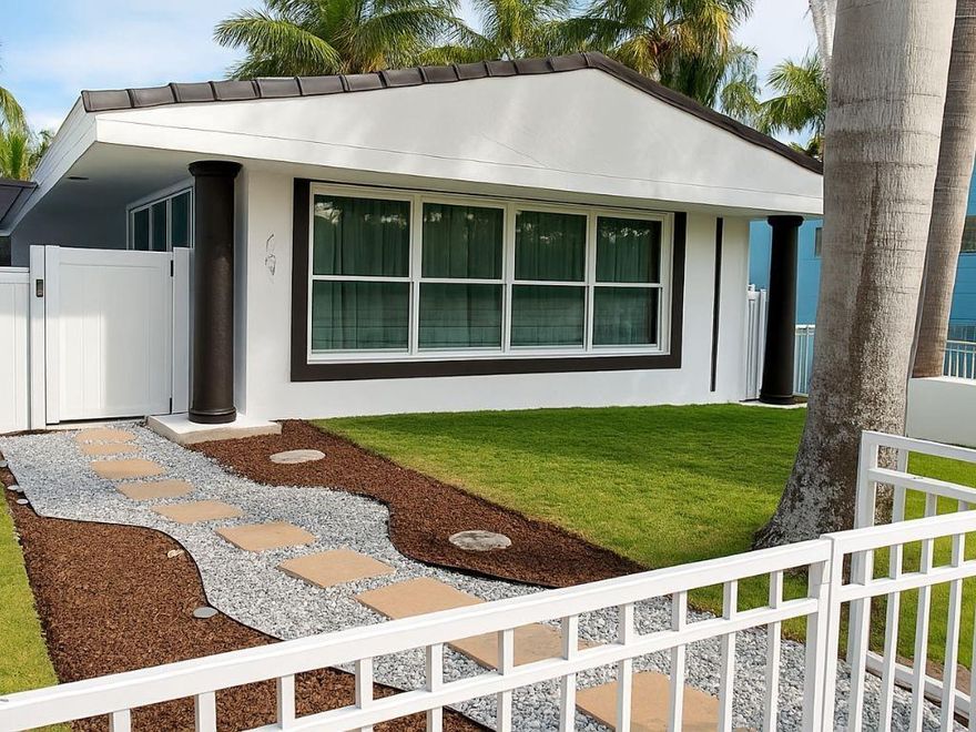 Walk to Hollywood Bch from this beautiful 3BR/2BA on a corner lot in historic Hollywood Lakes. 1,710 sqft, partially furnished, blending comfort & elegance w/modern finishes.  Stunning remodeled kitchen w/quartz countertops & stainless steel appliances. New roof (2024) w/high efficiency insulation, Renovated bathrooms (2025), Terrace deck (2025), Electric gate, Perimeter fence & pergola, Newer A/C, PVC plumbing, Impact windows & doors, Gas hotwater & water filtration system for entire house, tile flrs & recessed lighting. Open living-area overlooks new oversized heated jacuzzi, tropical landscaping, & luxury outdoor kitchen. Perfect for entertaining & enjoying coastal living. 1 block to direct ocean access community boat ramp. Minutes to Downtown, & FLL Airport. No HOA!