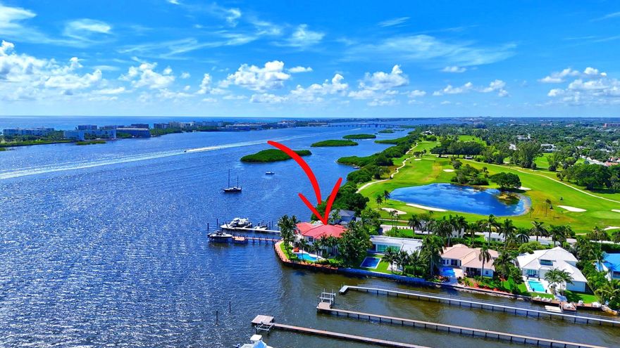 This Intracoastal estate offers an unparalleled blend of luxury, privacy, and convenience, set against the backdrop of breathtaking Intracoastal and Palm Beach Island views. Located in an exclusive gated enclave of 7 homes ensuring ultimate privacy and tranquility. 210' of direct intracoastal frontage, with a 210 ft. dock and two deep-water boat slips accommodating vessels up to 50 - 60ft. without obstructing views. Potential to expand private dock to accommodate an even larger yacht. Includes a boat lift and separate lift for jet skis. Northeast-facing in back with sweeping Intracoastal vistas, stunning sunrises, and refreshing breezes for perfect outdoor entertaining and relaxation.  Impressive living areas with soaring ceilings and impact windows that fill the home with natural light.