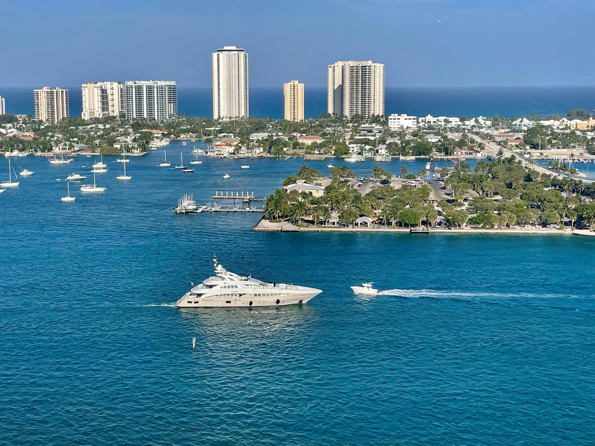 Gorgeous direct, unobstructed views of the Intracoastal Waterway and Atlantic Ocean from this preferred Ocean Tower, 23rd-floor residence at Marina Grande. Enjoy breathtaking sunrises and refreshing ocean breezes from your spacious balcony, living room, and owner's suite. Desirable split floor plan features 2 bedrooms plus a large den--ideal for a home office or 3rd bedroom. The chef's dream kitchen boasts seating for six at the countertop bar, new custom cabinetry, white quartz countertops, a turquoise glass backsplash, and premium Kenmore & KitchenAid stainless steel appliances, including induction cooktop, warming drawer, and convection oven. The owner's suite is a relaxing retreat with dual white custom vanities, a walk-in shower with frameless glass doors, a separate water closet, and