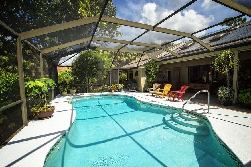 PRE-INSPECTED home for your convenience. Pet friendly community. Half an Acre of amazing Outdoor & indoor Living Space! Covered lanai with TV living & dining area, swimming, game & bar area  Watch the football game from the solar heated pool! Convenient cabana bath. Awesome yard for all your get-togethers. Circle drive for good parking. All this plus a wonderful spacious home, perfect for entertaining. Sliders pocket back into the wall so kitchen family room become a seamless entry to the outdoors. Extensive professional landscaping/lighting. Ask for the feature sheet for all the New Upgrades including a New Roof! City Water! Community pool, tennis, basketball & boat ramp.  Non commercial trucks and boats are welcome. If outdoor living is what you are looking for...do not miss this home!