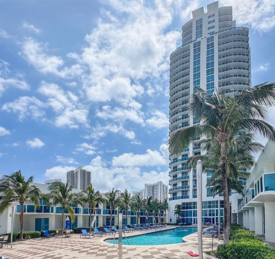 Walk to the beach! Enjoy spectacular north-facing views of the ocean, city, and Intracoastal. This spacious 2-bedroom, 2.5-bath condo offers an open, split floor plan, large balcony, impact windows, laundry room, and a NEW AC. The beautiful kitchen features granite countertops and stainless steel appliances. Both bedrooms are generously sized, with the master suite offering a walk-in closet, dual sinks, a tub, and a separate shower. Building amenities include an outdoor heated infinity-edge pool with cabanas, fitness center, business center, and a game room with a pub. Additional services include concierge and valet parking, plus assigned parking and storage.