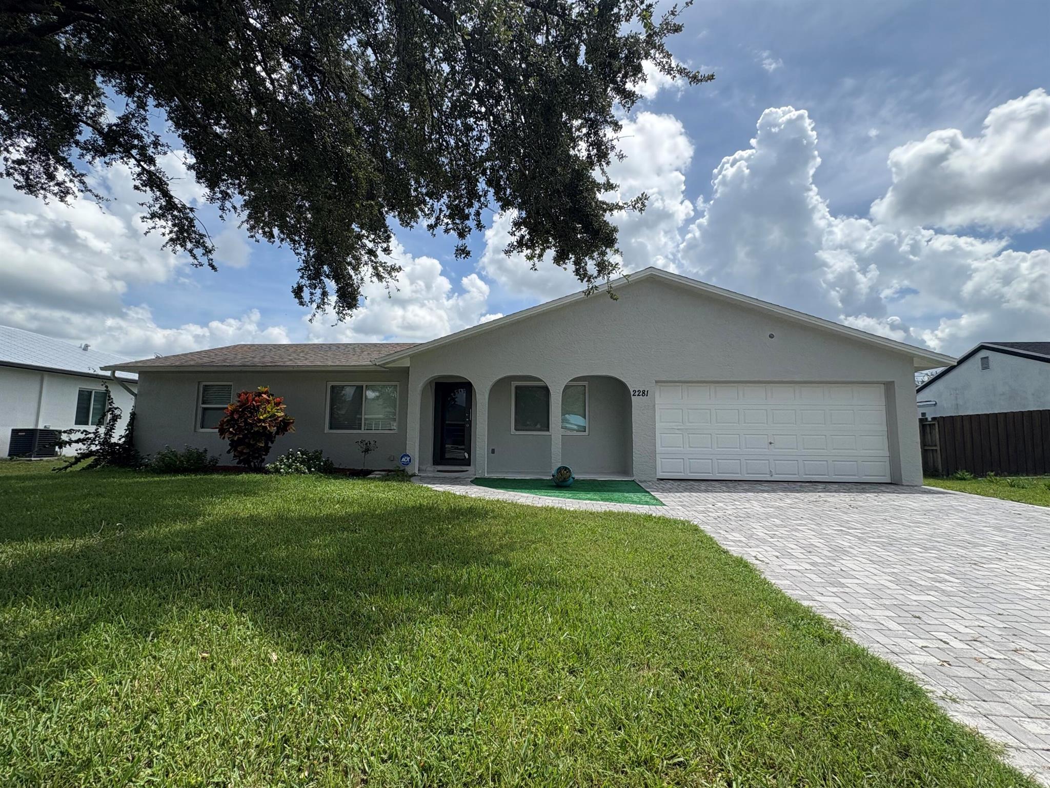 This 3-bedroom, 2-bath home has been completely updated and feels brand new. You'll love the open living and dining spaces with tile floors throughout, perfect for everyday living and hosting friends. There's even a cozy coffee spot to start your mornings. Spacious walk-in closet in the master bedroomThe backyard is fully fenced with plenty of room for a pool or weekend BBQs. Plus, the long driveway means parking is never an issue. Big updates are already done: brand-new roof, impact windows, new A/C, and water heater.All this, just minutes from restaurants, shopping, and the beach.
