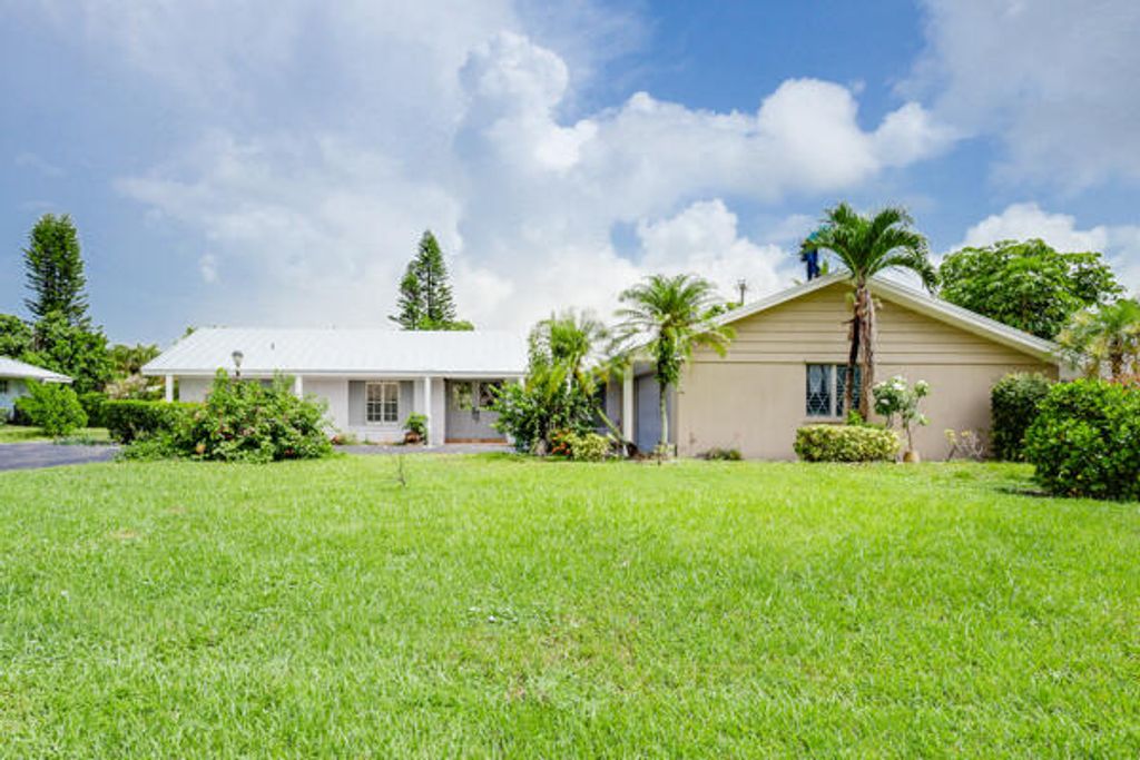 Photo of 220 N Country Club Drive, Atlantis, FL 33462 (MLS # R11005977)