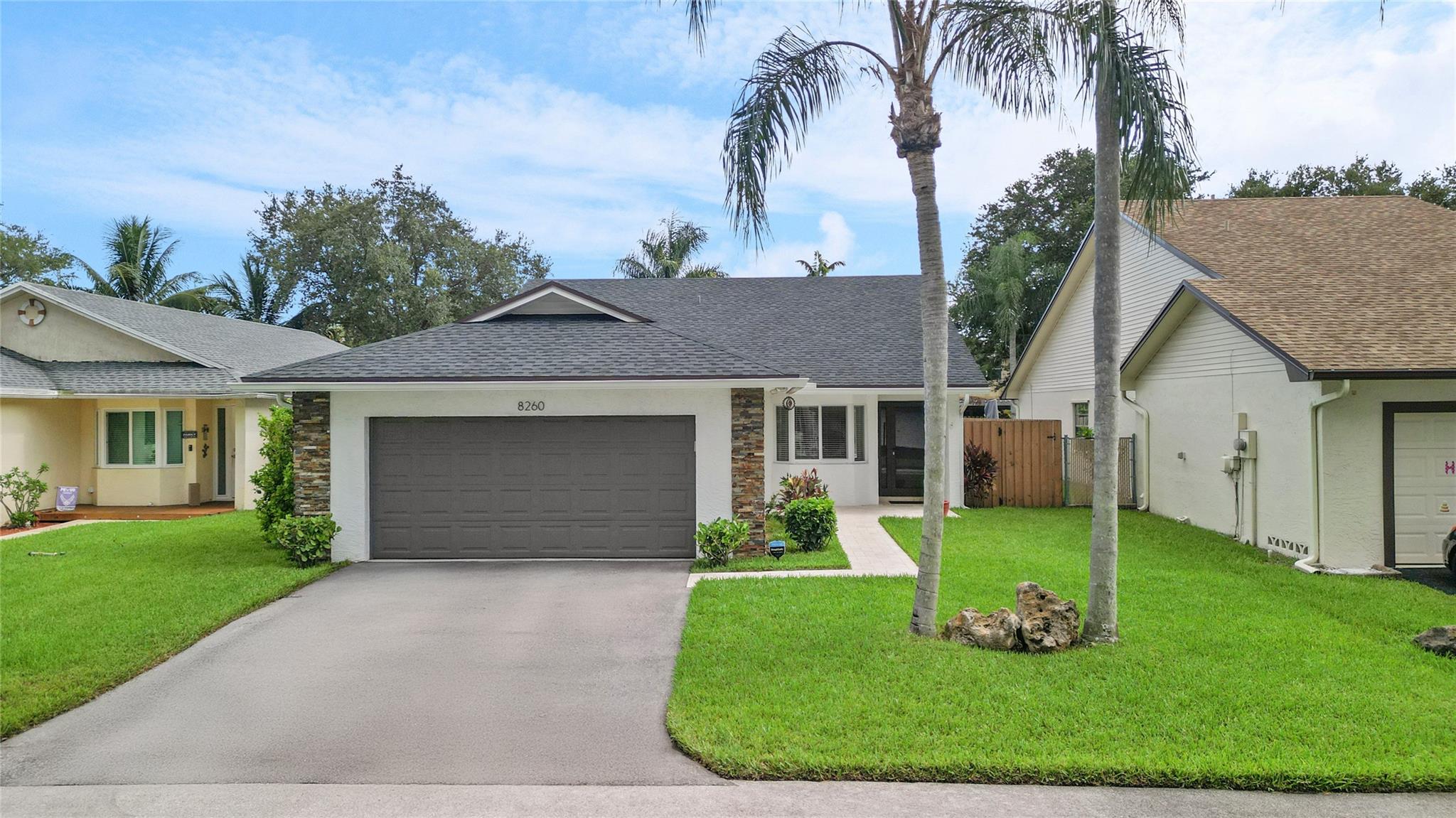 Welcome to this stunning 3-bed, 2-bath single family home that seamlessly blends comfort, style and peace of mind. Attention to detail and high-quality updates make this home truly move-in ready. The heart of the home features a beautifully updated kitchen complete with sleek quartz countertops, modern cabinetry, and stainless steel appliances-perfect for cooking and entertaining. Enjoy peace of mind with a new roof installed in 2022 and impact-resistant windows and doors throughout, offering safety and energy efficiency. The spacious master suite includes an updated en-suite bathroom. Updated tile flooring runs throughout the home. Outdoor spaces shine with travertine pavers on the front walkway and back patio, creating a clean and elegant look. Located near Walmart, Publix, and parks.