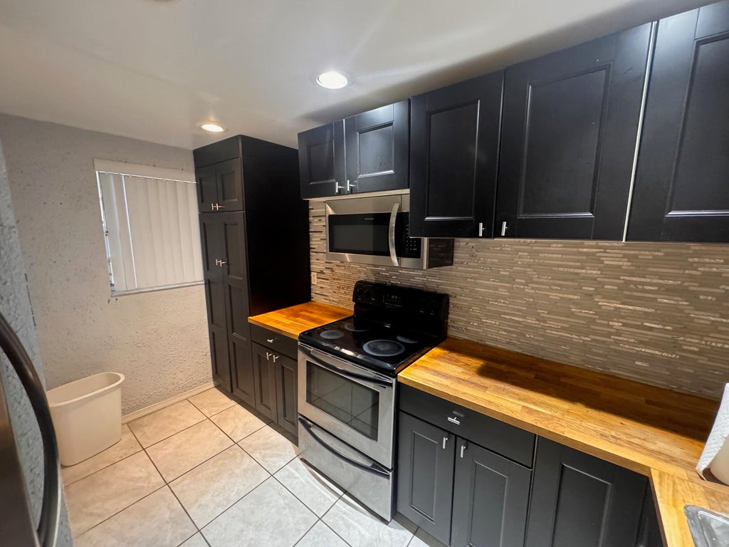 Photo of 9480 Poinciana Place #310, Davie, FL 33324 (MLS # B26061275)