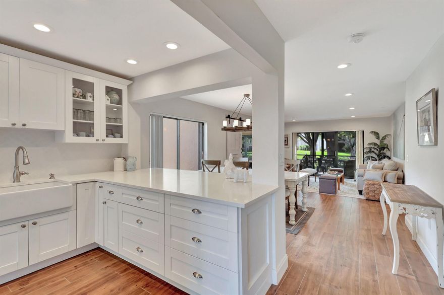 This elegant, inviting, charming and modern 3-bedroom, 2-bathroom condo is the one for you. The setting is peaceful,offering a serene environment for its residents. The highlight of the property is its beautiful water view, which adds to the tranquility of the surroundings. The interior features porcelain tile floors throughout, which not only enhance the aesthetic appeal but also offer durability and ease of maintenance. Stunningly renovated kitchen featuring a farmhouse sink and quartz countertops. The updated bathrooms showcase carrera marble floors and shower enclosures. Enjoy the expansive screened-in lanai with convenient access for your golf cart and pull-down shutters for added privacy and safety. This home has hurricane shutters throughout. Relish in the tranquility of the private side patio complete with golf cart hookup. Hunters Run is a mandatory buy-in and yearly membership, amenities-filled community, offering 3 championship 18-hole golf courses, tennis & pickle ball courts, 7 dining venues, pools, a fitness center, spa & salon, golf shop, entertainment & activities. Just minutes to vibrant downtown Delray and the BEACH! Come to Hunters Run the only thing missing is you!