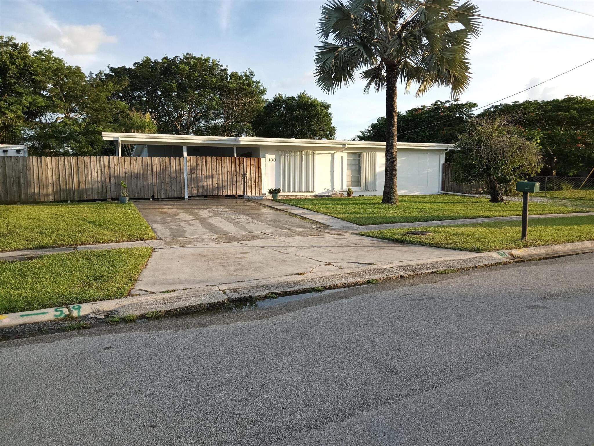 This charming property offers privacy, space, and immediate availability. Built in 1961, this durable concrete block home features vaulted ceilings, a poly-coated roof, stainless steel appliances, remodeled bathrooms, and new tile flooring.Set on a fenced lot with room for a pool and a 60x40 building, it backs onto county easement with trail excellent for outdoor adventures. Lush landscaping includes shade hammock of oak, earpod, bismark palm, ponytail palm, bougainvila, an aloe/cactus garden, with serene forest views from an 28x18 patio.Highlights include a master suite with a private entrance/kitchenette, an air-conditioned workshop, hurricane shutters, and a 10kW generator. The seller will install a new HVAC system with signed PA/NRD.