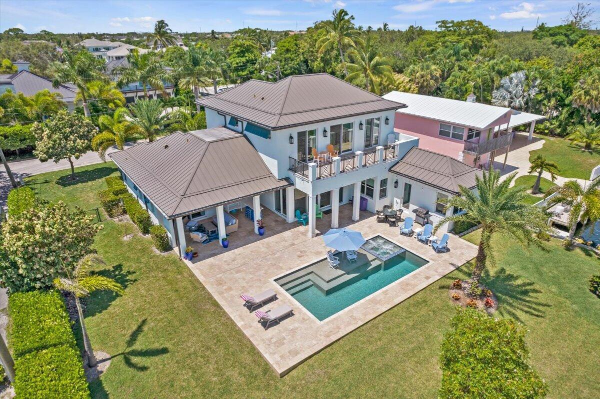 Luxurious Waterfront Oasis: Seasonal Rental in Jupiter, Florida. Available for next season 2026. Escape to this exceptional West Indies-style waterfront home in Jupiter, Florida. Built in 2018, this 5-bedroom, 4-bathroom residence with a private dock and 2 car garage offers the perfect blend of luxury and coastal living for your extended winter stay. This exquisite home features an open floor plan bathed in natural light, showcasing breathtaking water views from every room. The gourmet chef's kitchen boasts high-end appliances, a large center island, and a spacious pantry, perfect for culinary enthusiasts. Unwind in the casually elegant dining room or expansive great room. The ground floor owner's suite provides a serene retreat with its spa-like bathroom featuring