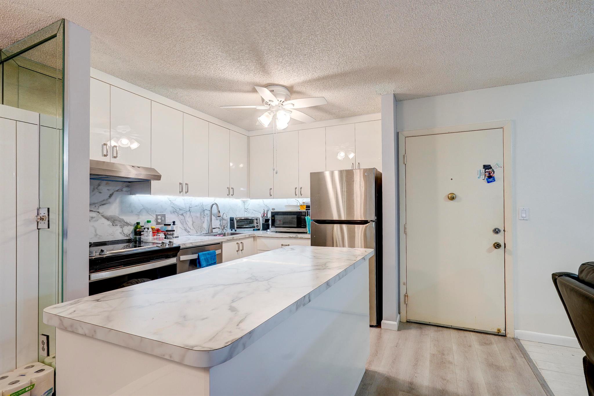 Charming 2-Bedroom, 2-Bath Condo in the Exclusive 55+ Gated Community of Belfort at Kings Point, Tamarac. Experience the best of active adult living with this beautifully updated first-floor condo. This inviting home features an upgraded kitchen and bathrooms, offering modern convenience and style. Enjoy peace of mind with a new water heater installed in 2022 and a brand-new AC system added in 2023. This condo offers the perfect blend of comfort, convenience, and vibrant community living. Don't miss this opportunity to make Belfort at Kings Point your new home.
